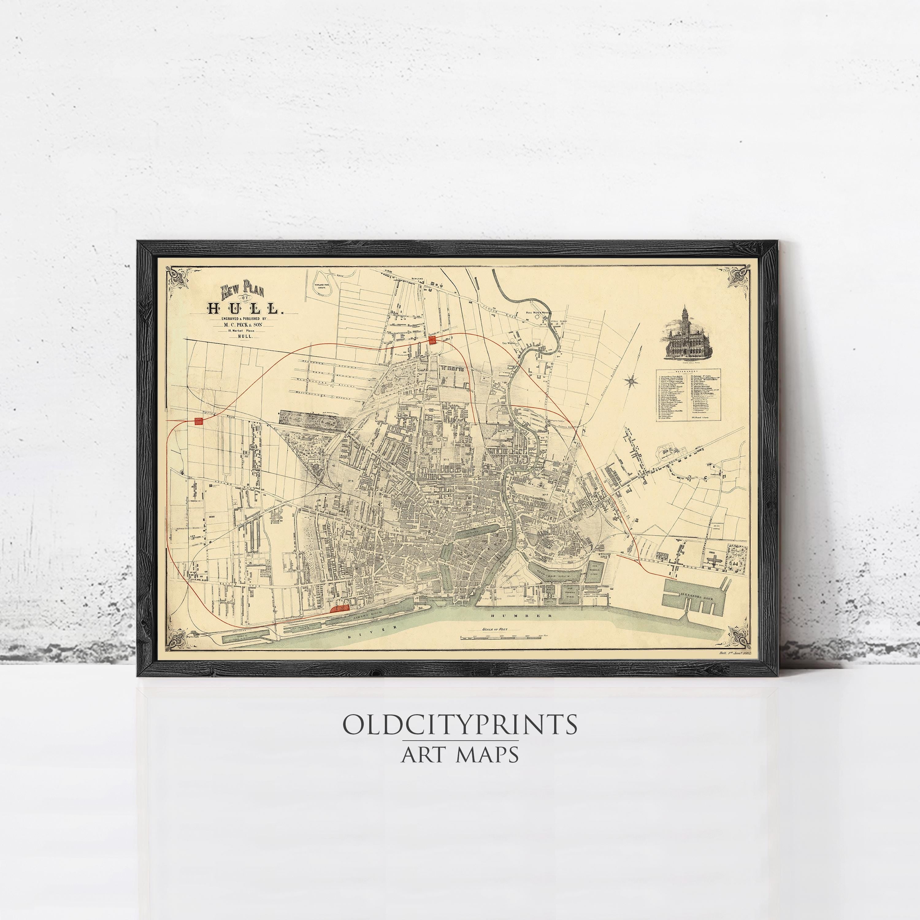 The image is a framed vintage map of a city, likely from the 19th century, with detailed street and building plans.