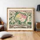 The image is a framed vintage map of a city, depicting a detailed layout of the city's streets, landmarks, and surrounding areas.