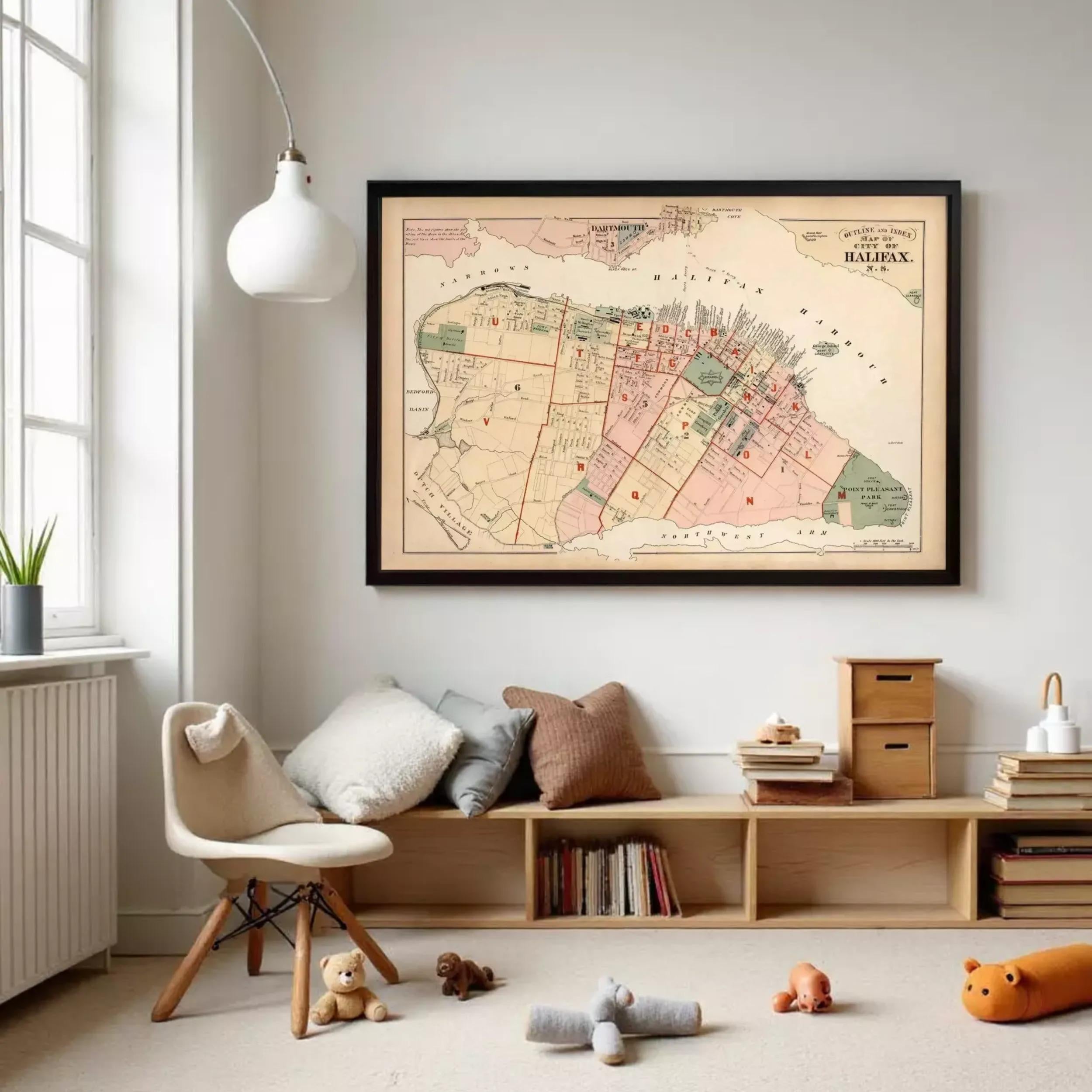 a cozy living room with a large framed map of Montreal, Canada, hanging on the wall. The room is decorated with a comfortable chair, a bookshelf filled with books, and a teddy bear. There are also some stuffed animals scattered around the room, adding a playful touch to the space.