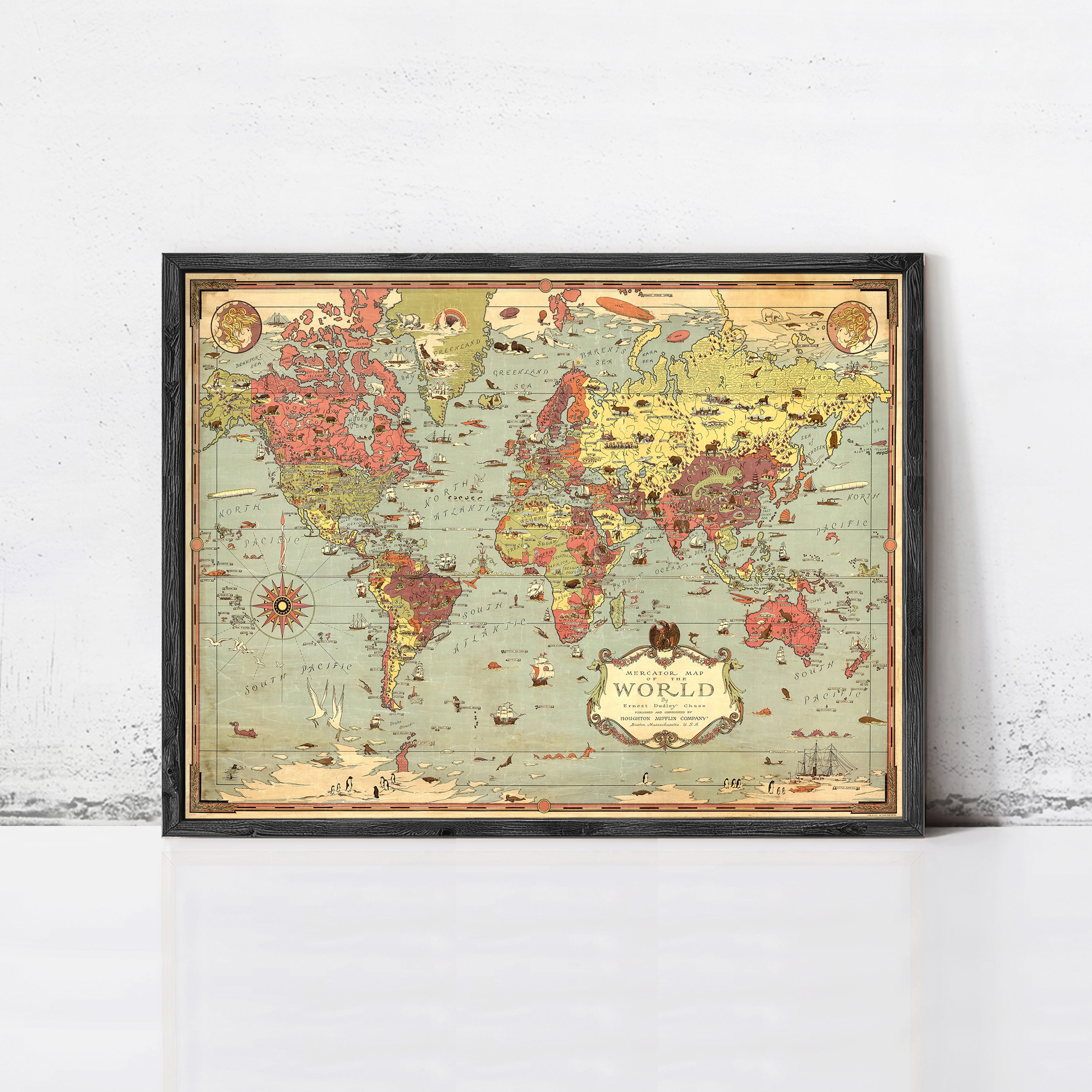 The image is a framed vintage world map with a black border and a decorative border around the edges.