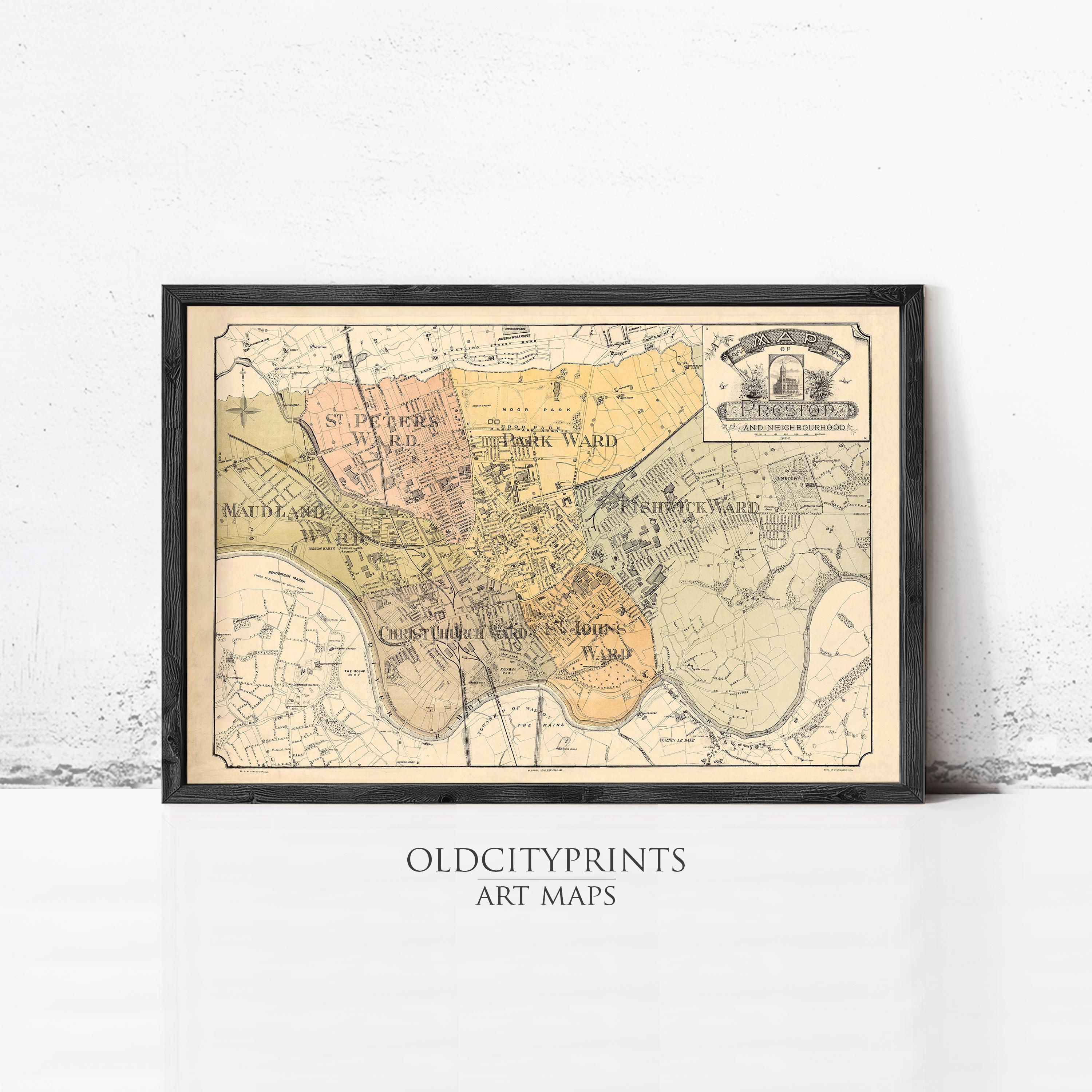 The image is a framed vintage map of a city, likely from the 19th century, with various colored areas representing different neighborhoods or districts.