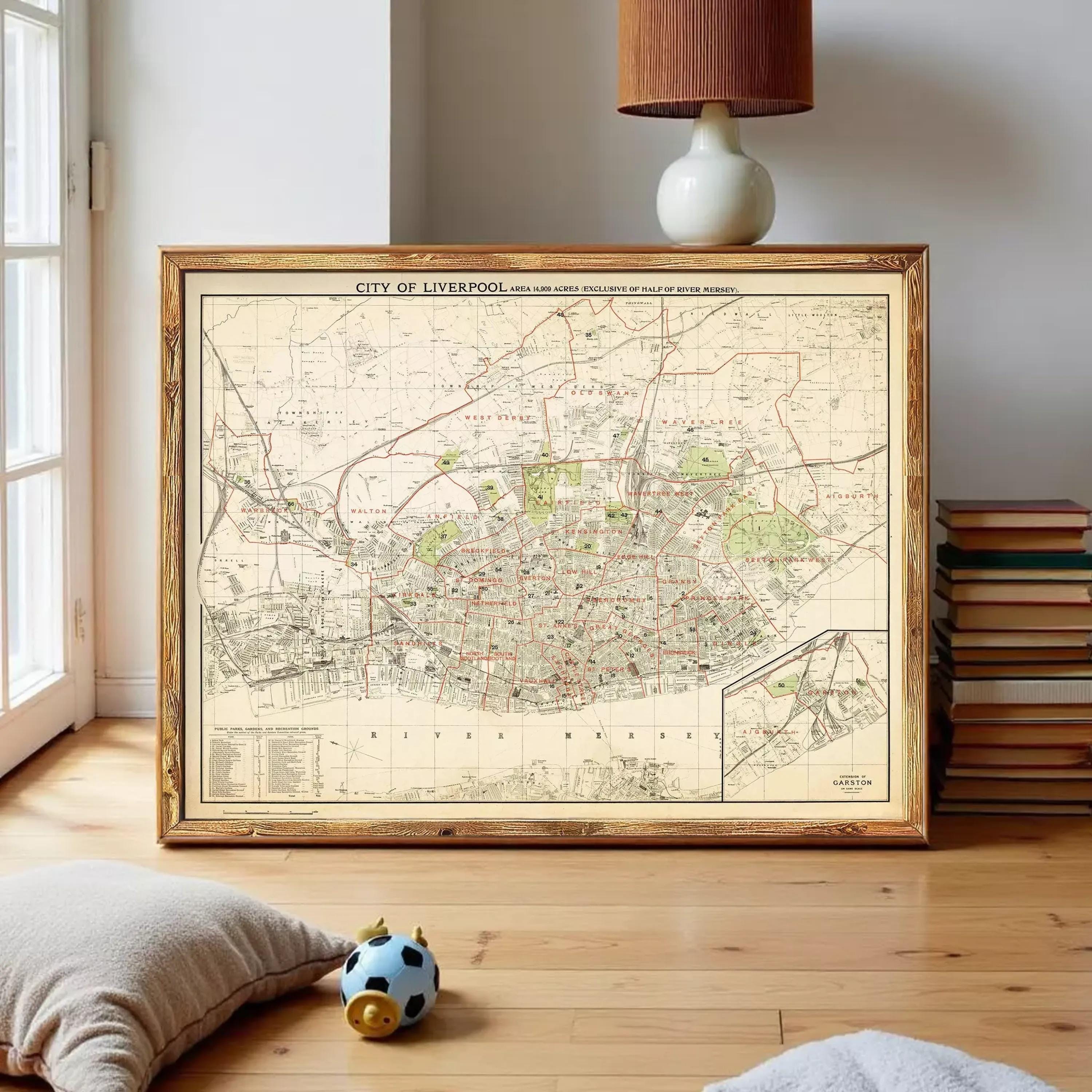 a framed map of Liverpool, with a lamp and a stack of books visible in the background.