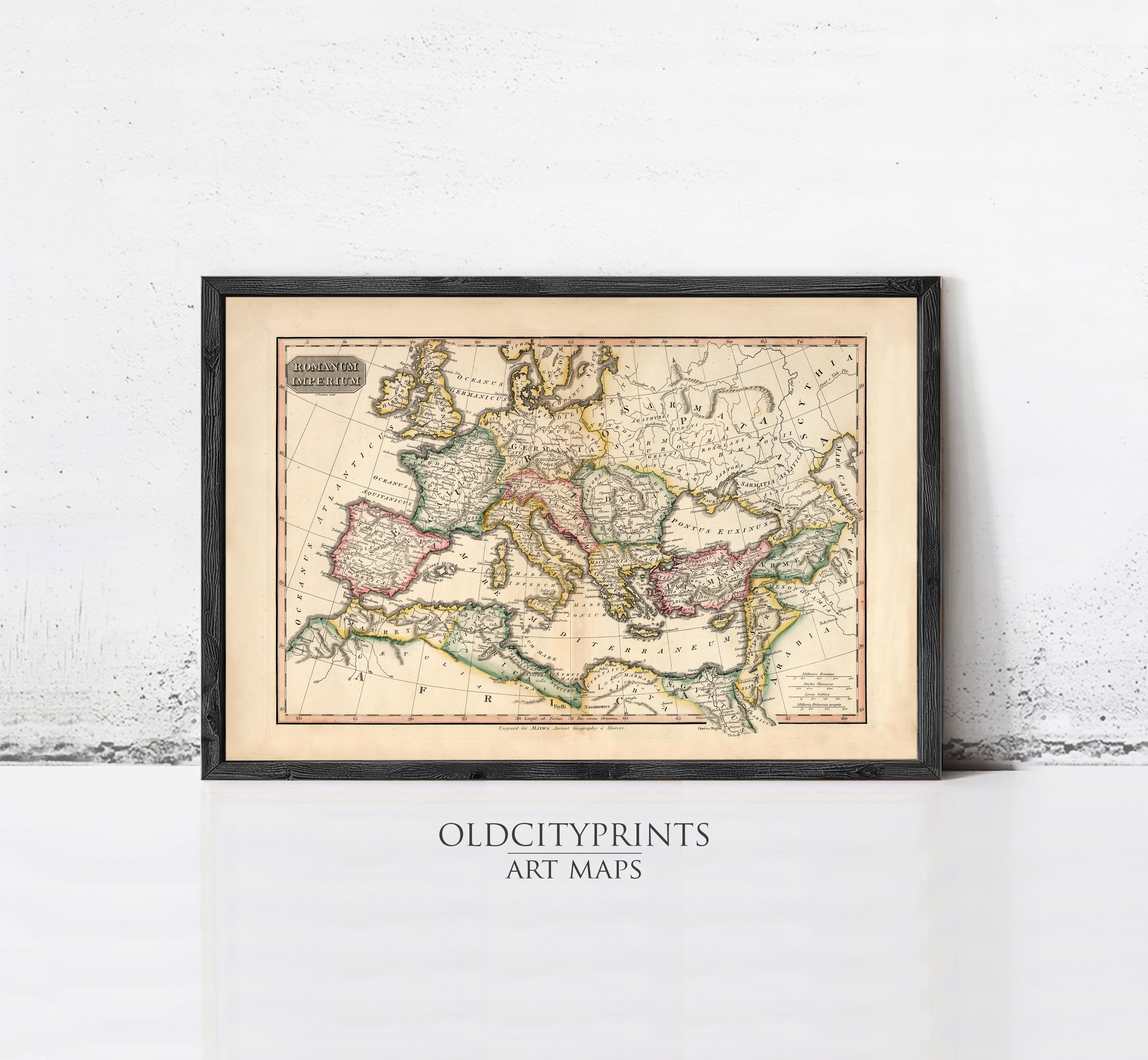 The image is a framed antique map of Europe and the Mediterranean region, displayed on a white wall.
