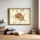 The image is a framed map of a city, likely a historical or geographical map, displayed on a wall.