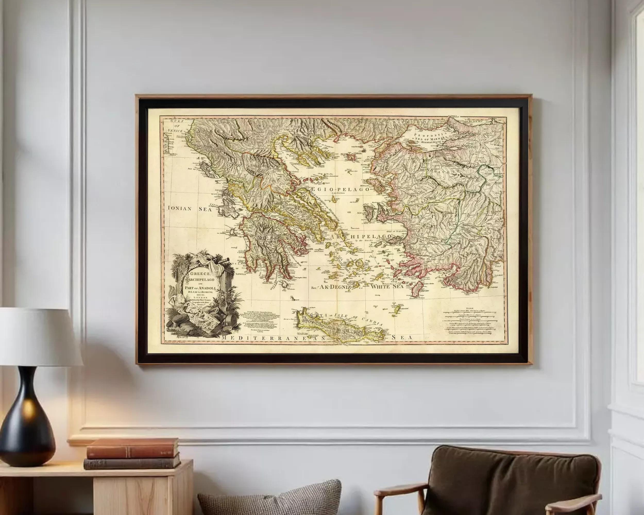 a large framed map of Greece hanging on a wall in a room.