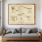 a large, framed map of the Caribbean Sea hanging on a wall above a gray sofa.