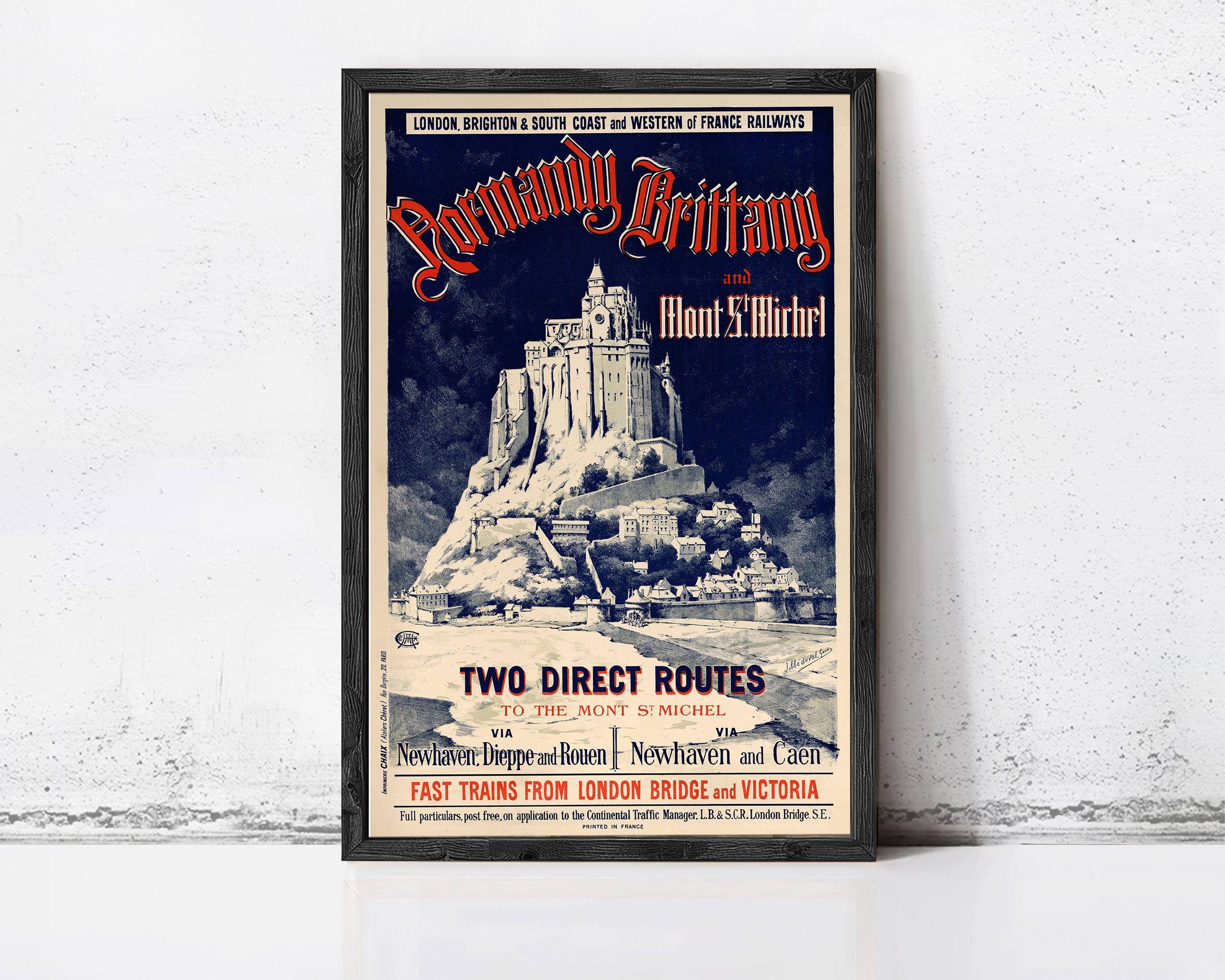 The image is a framed poster advertising a tour of the Mont Saint-Michel in the city of London, featuring a castle-like structure on a mountain.