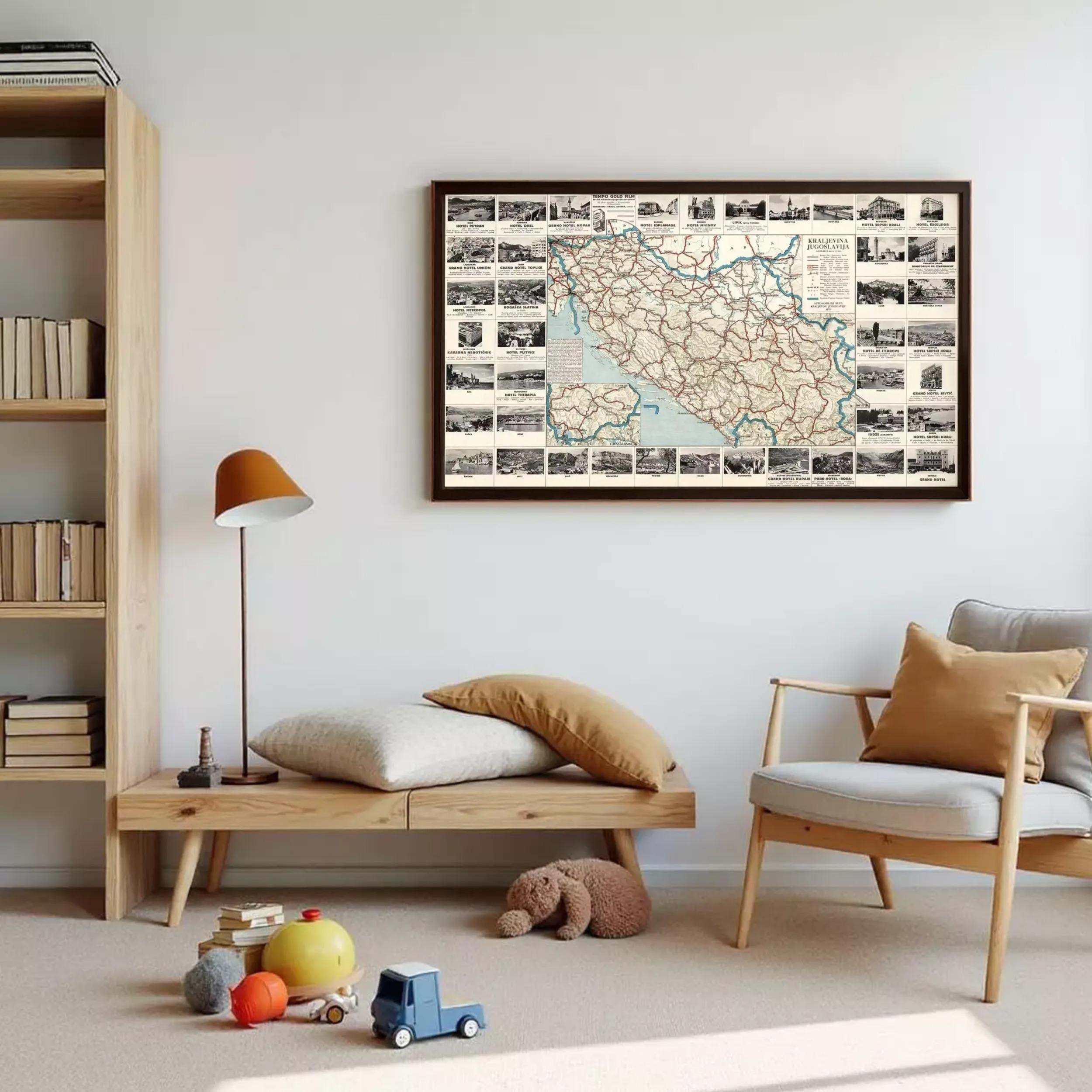 a cozy living room with a large framed map hanging on the wall, a wooden bookshelf, a wooden bench, a chair, and a teddy bear on the floor.