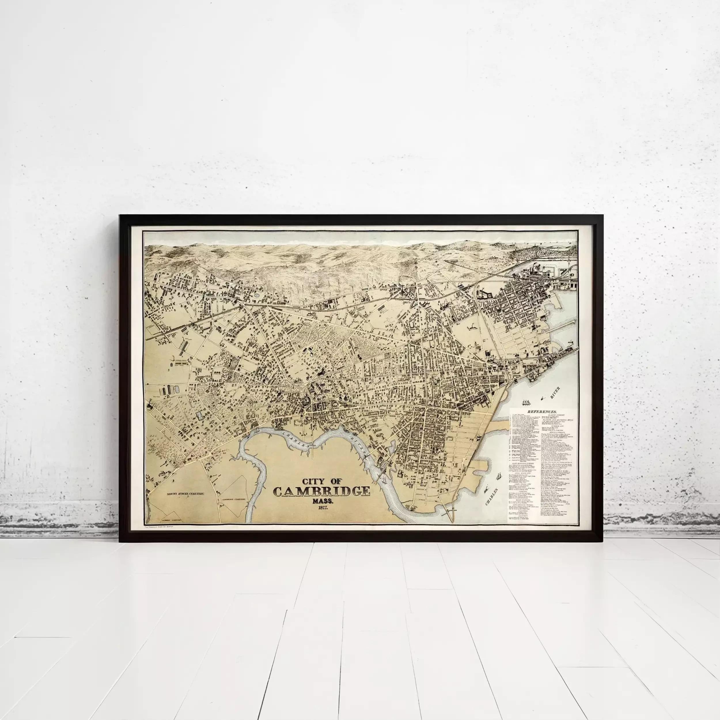 The image is a framed vintage map of Cambridge, Massachusetts, depicting the city's layout and surrounding areas.
