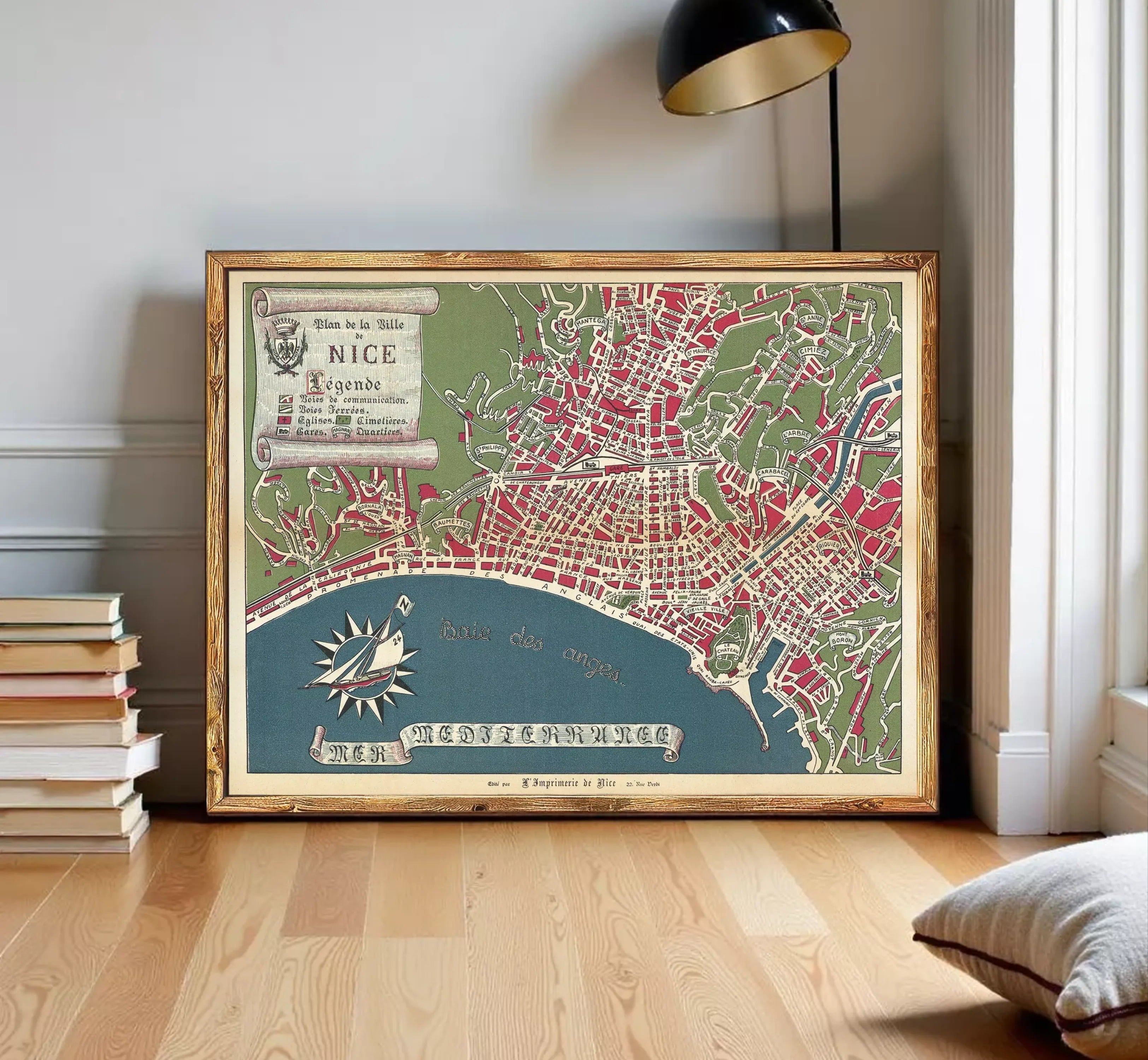 The image is a framed vintage map of Nice, France, depicting the city's layout and surrounding areas.