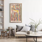 a cozy living room with a white sofa, a wooden coffee table, and a framed abstract painting hanging on the wall above the sofa.