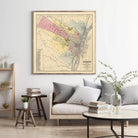 a living room with a large framed map of Albany, New York, hanging on the wall above a couch and a coffee table.