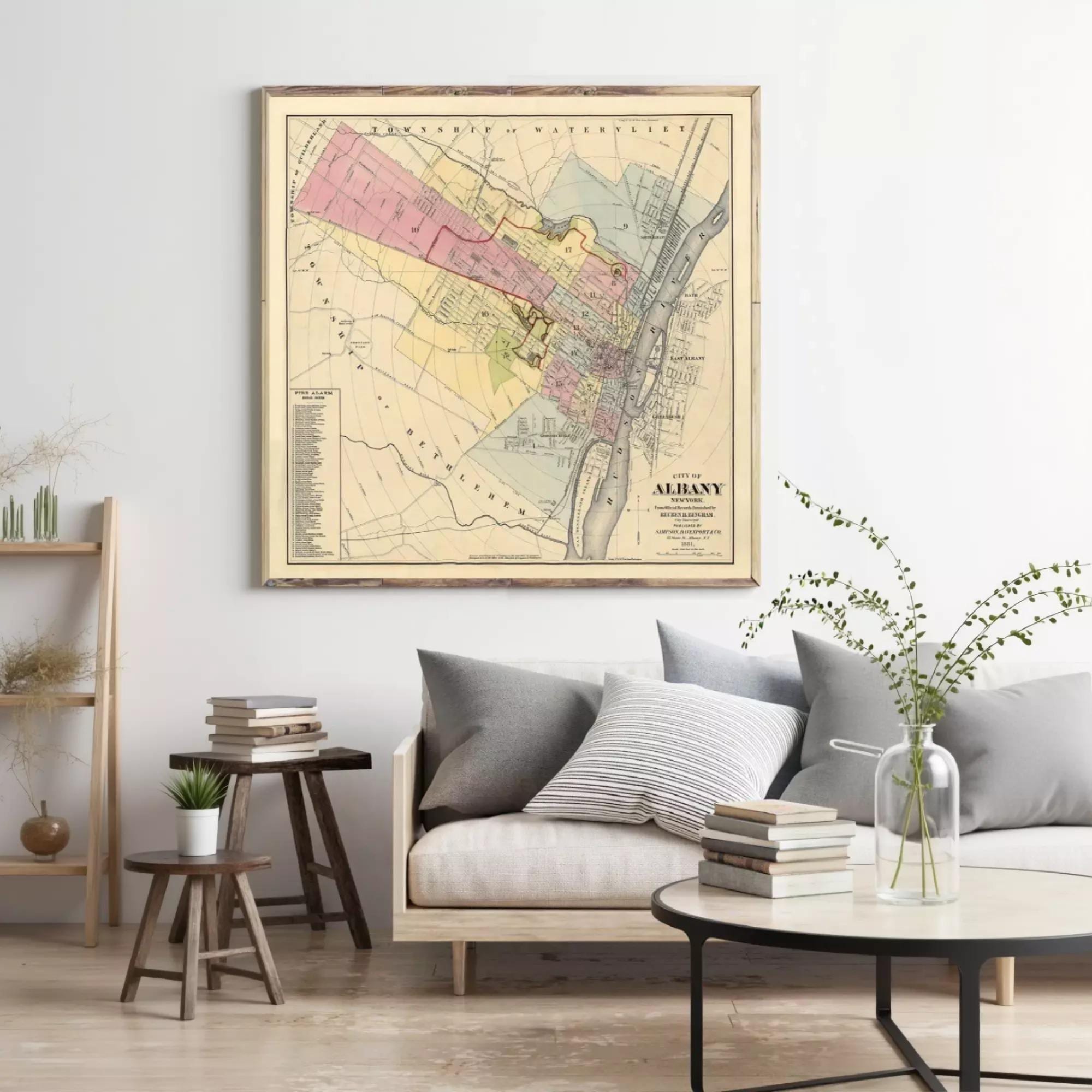 a living room with a large framed map of Albany, New York, hanging on the wall above a couch and a coffee table.