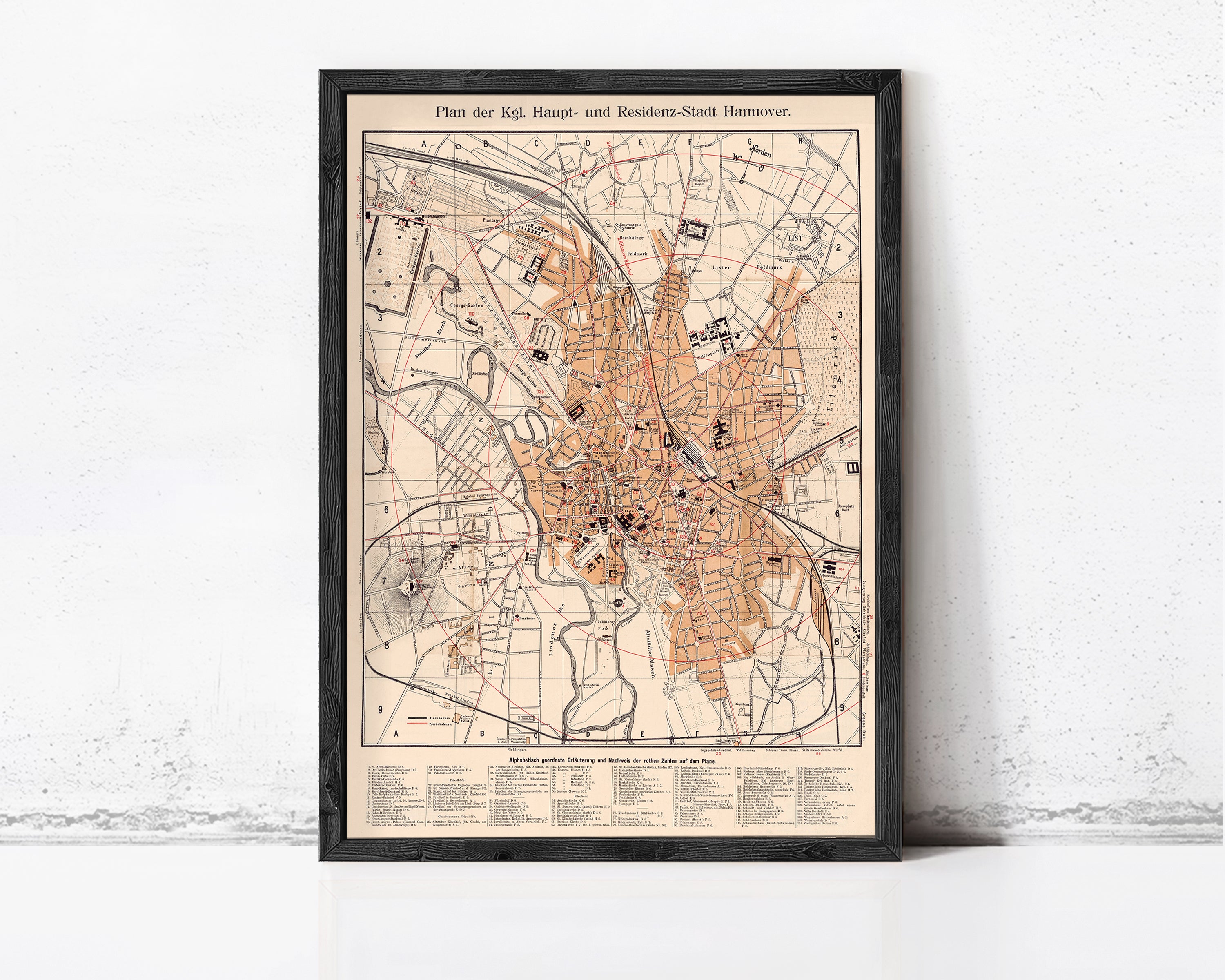 The image is a framed map of a city, likely a historical or geographical map, with various streets, landmarks, and other geographical features depicted.