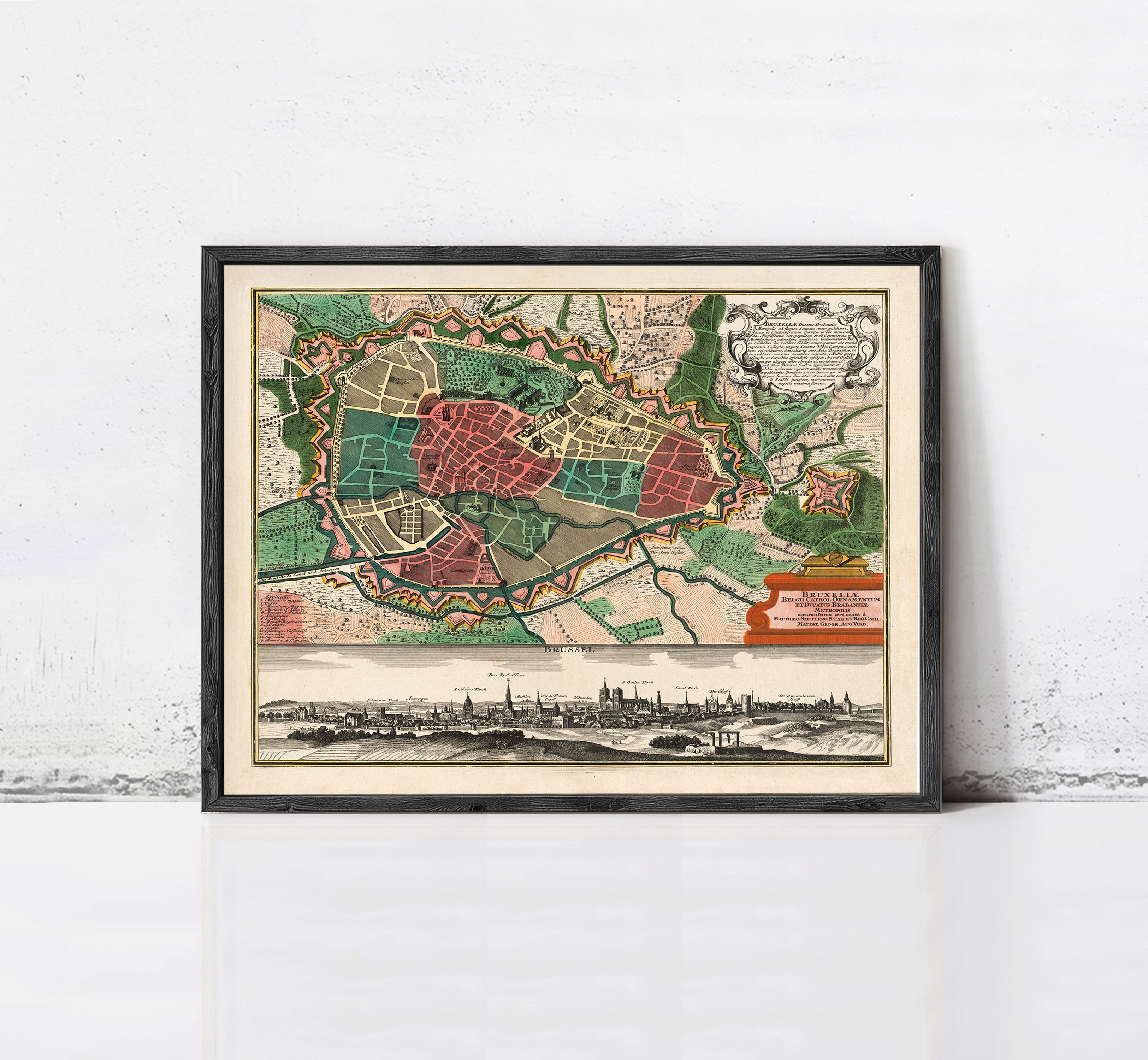 The image is a framed vintage map of a city, depicting a detailed layout of streets, buildings, and other urban features.