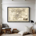 The image is a framed antique map of a city, likely from the 18th century, depicting a detailed layout of the city and surrounding areas.