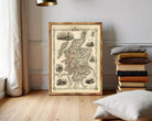 The image is a framed antique map of Scotland, featuring detailed illustrations and labels.