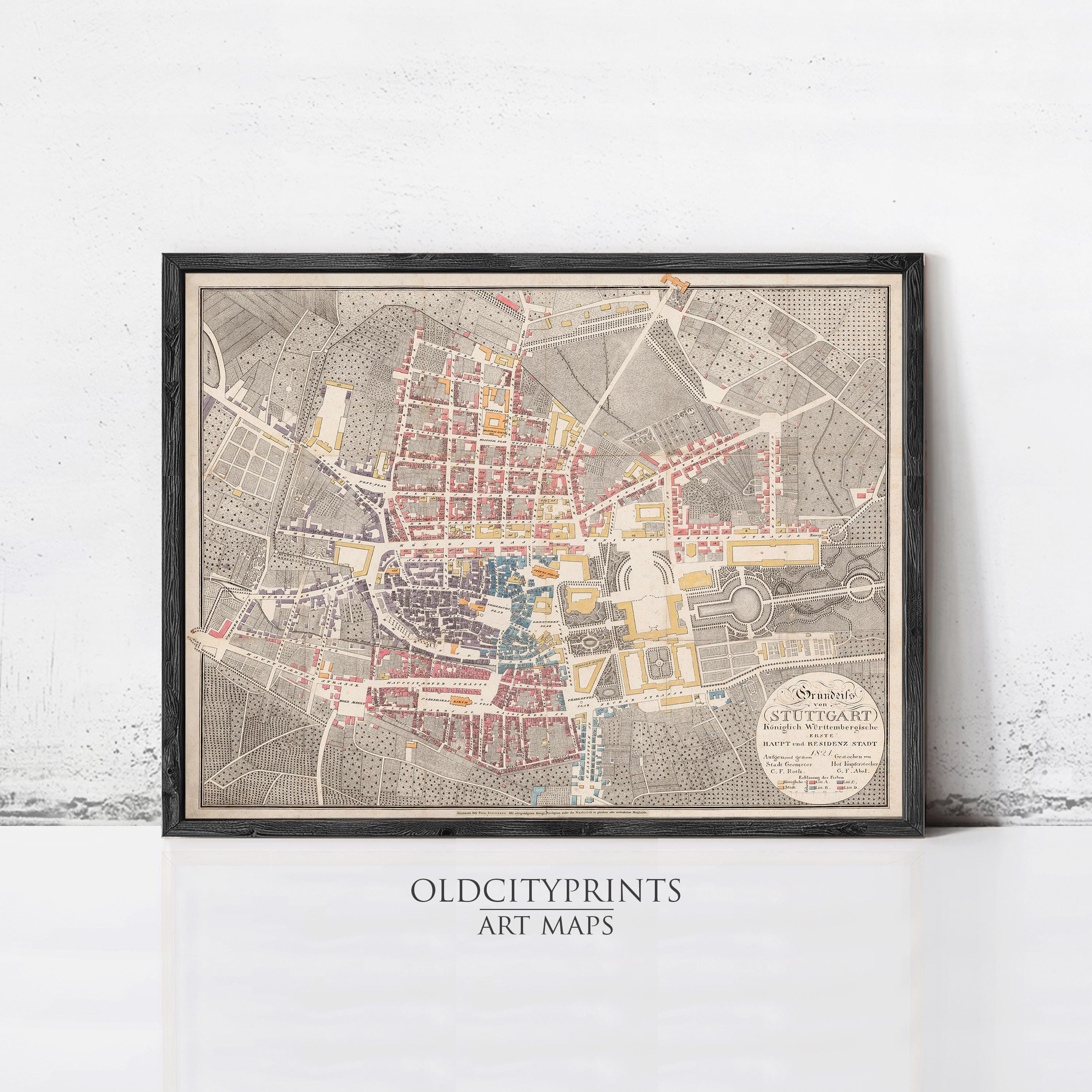 The image is a framed vintage map of a city, likely Stuttgart, Germany, with a detailed and colorful depiction of the city's streets, buildings, and landmarks.