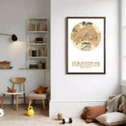 a cozy living room with a bookshelf, a chair, a small table, and a child's toy. A framed map of Staunton, Virginia is hanging on the wall, and there is a small stuffed animal on the floor.