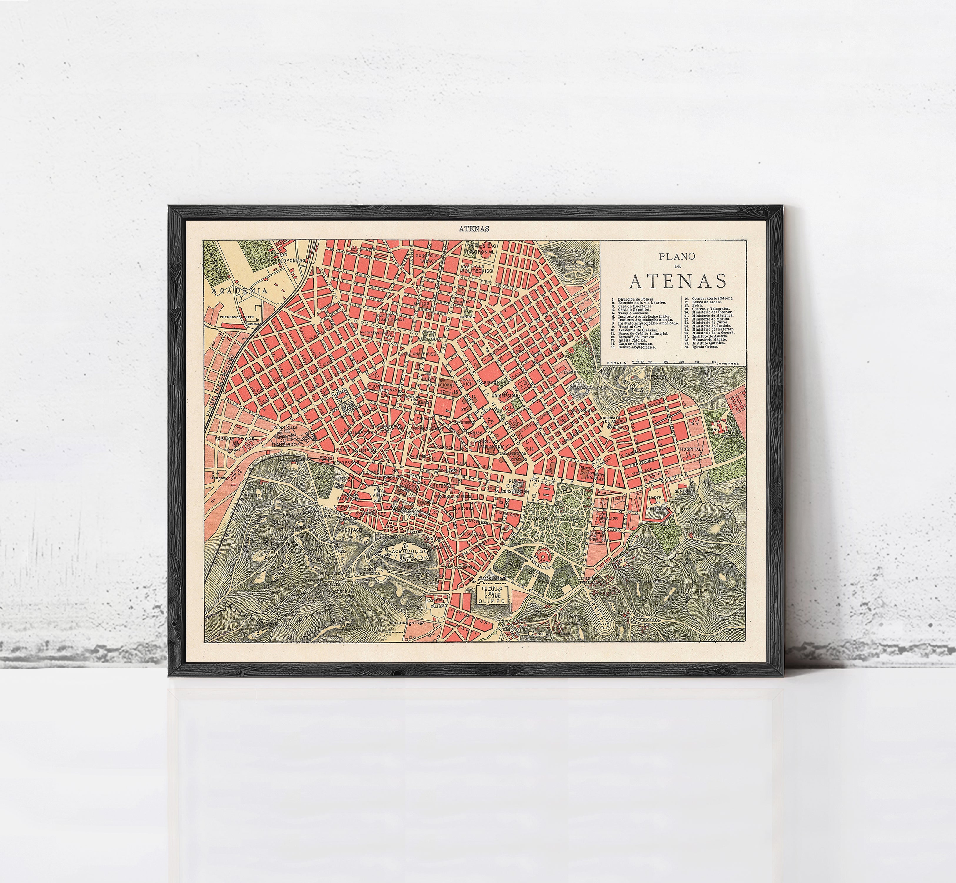 The image is a framed map of the city of Athens, Greece, depicting the city's streets, landmarks, and surrounding areas.