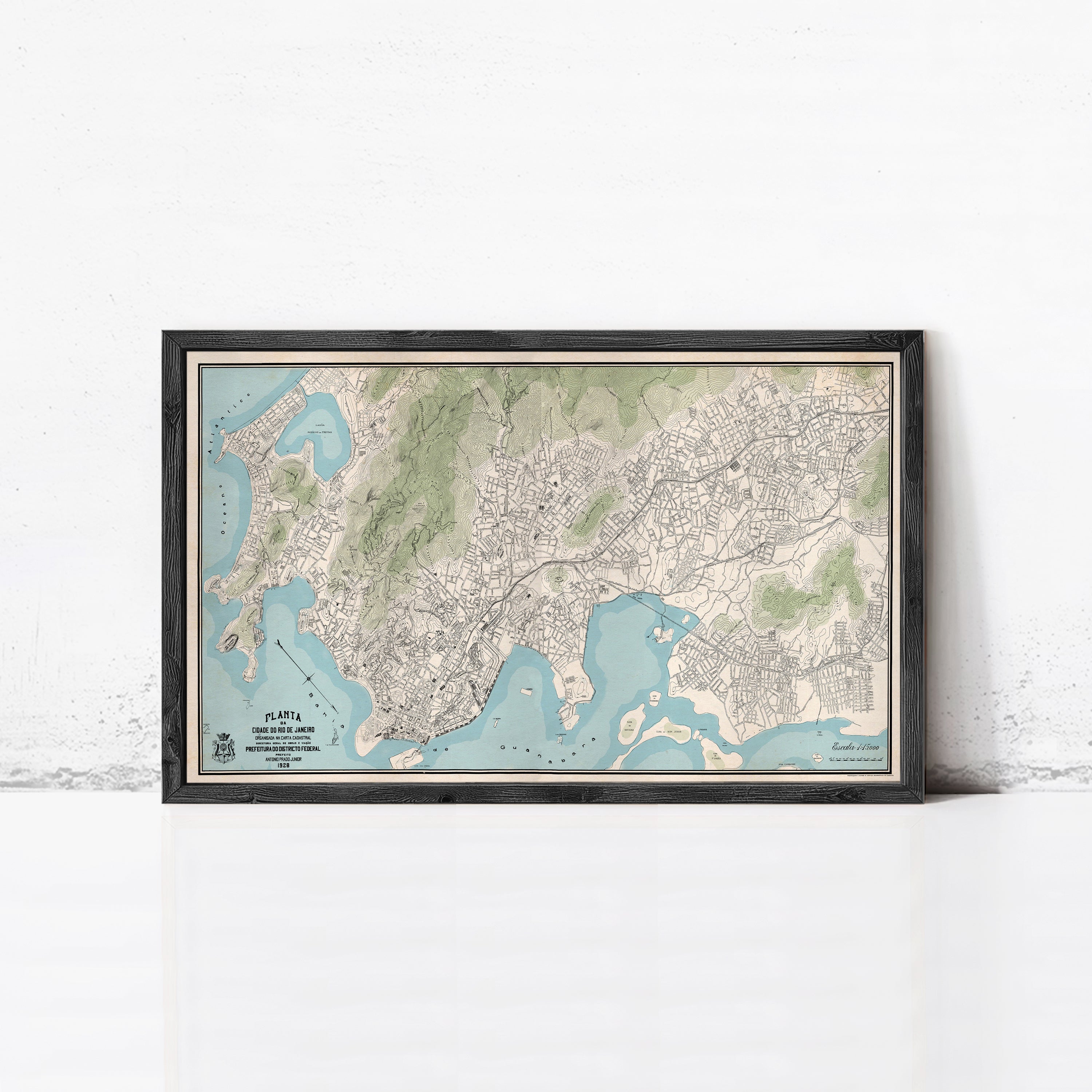 The image is a framed map of a city, likely a coastal city, with a detailed and intricate layout of streets, landmarks, and bodies of water.