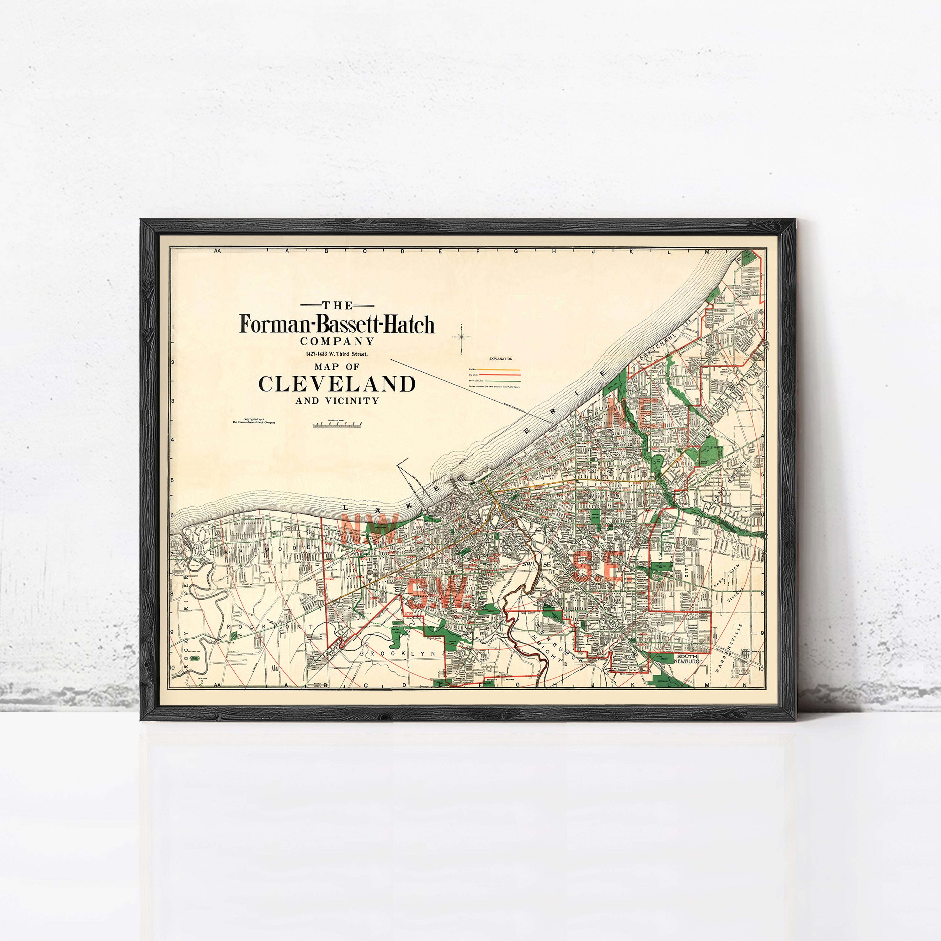 The image is a framed vintage map of Cleveland, Ohio, depicting the city's layout and surrounding areas.
