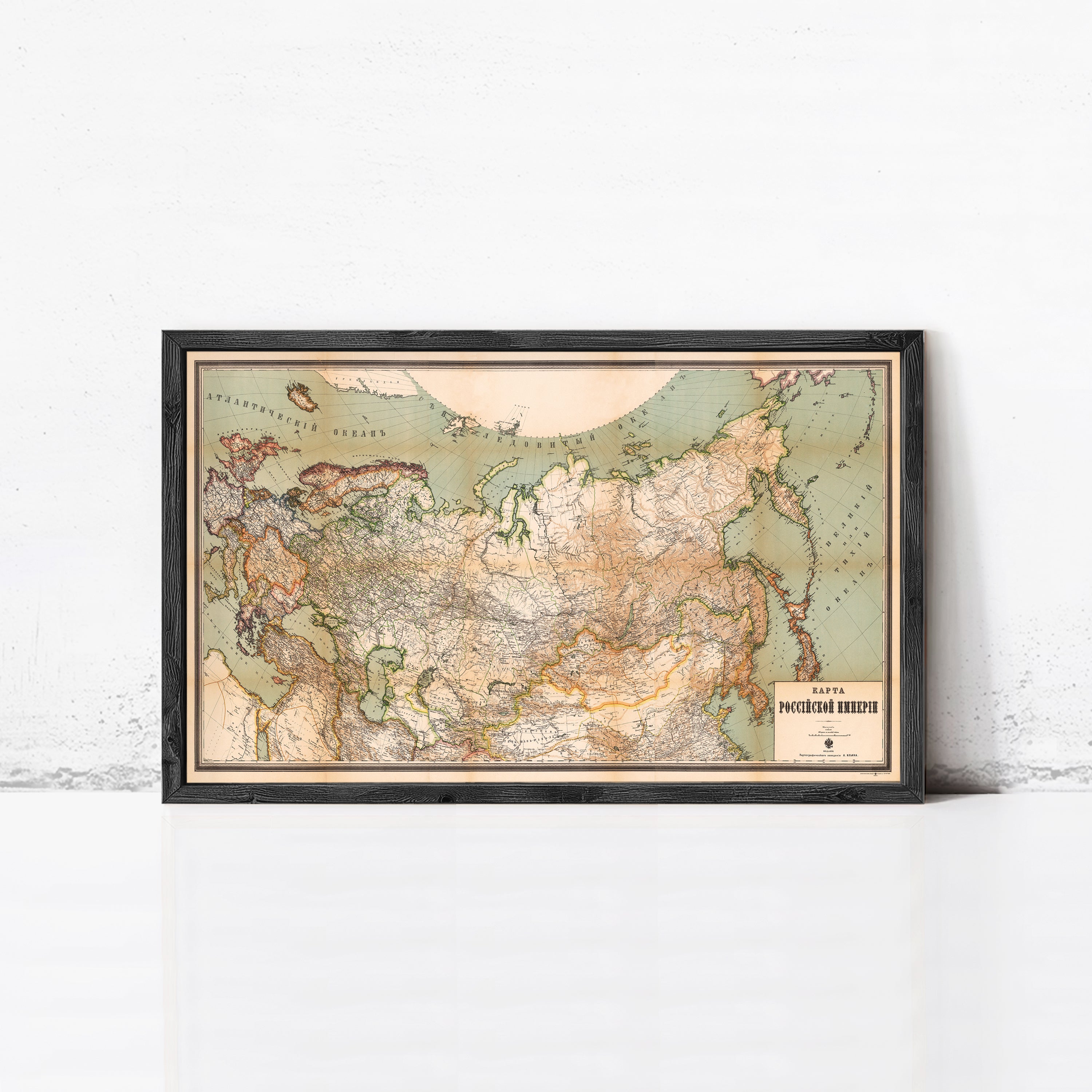 A framed map of the world, depicting the eastern half of Europe, Asia, and the Middle East, with a vintage style.