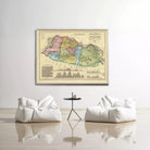 a large, colorful map of a region hanging on a wall, with two white bean bag chairs positioned in front of it.