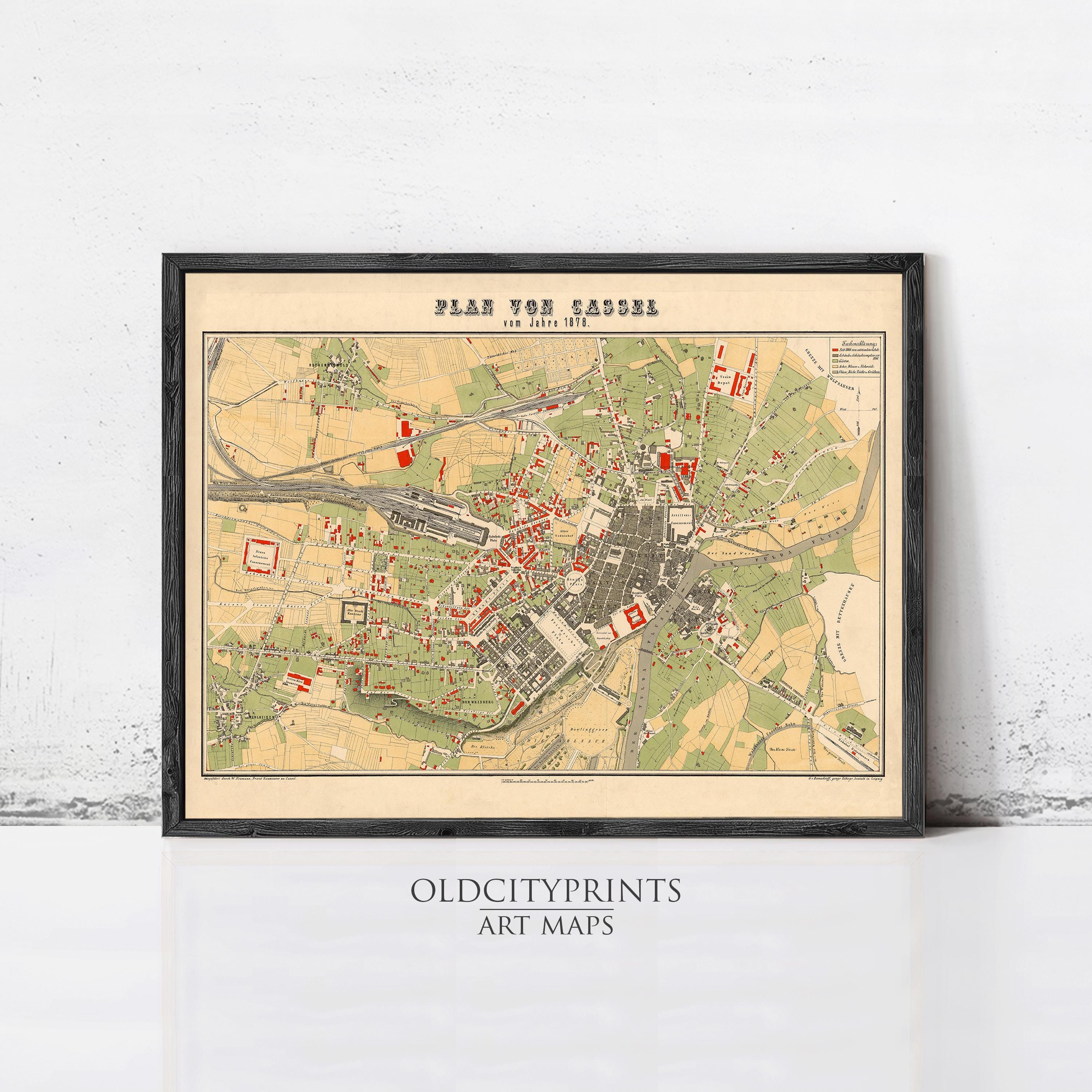The image is a framed vintage map of a city, likely from the 19th century, with various colored dots representing different locations or landmarks.
