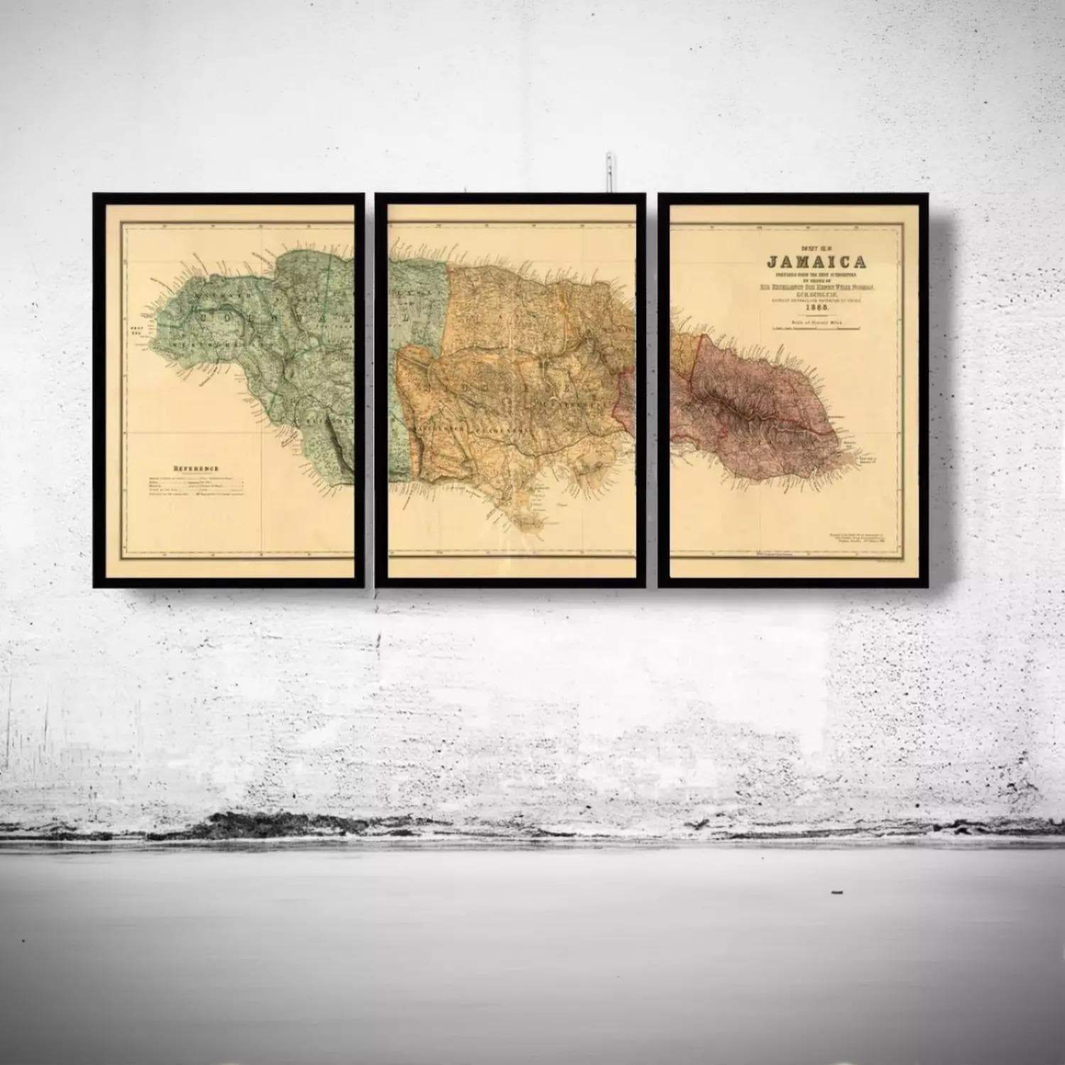 three framed maps of Jamaica hanging on a wall.