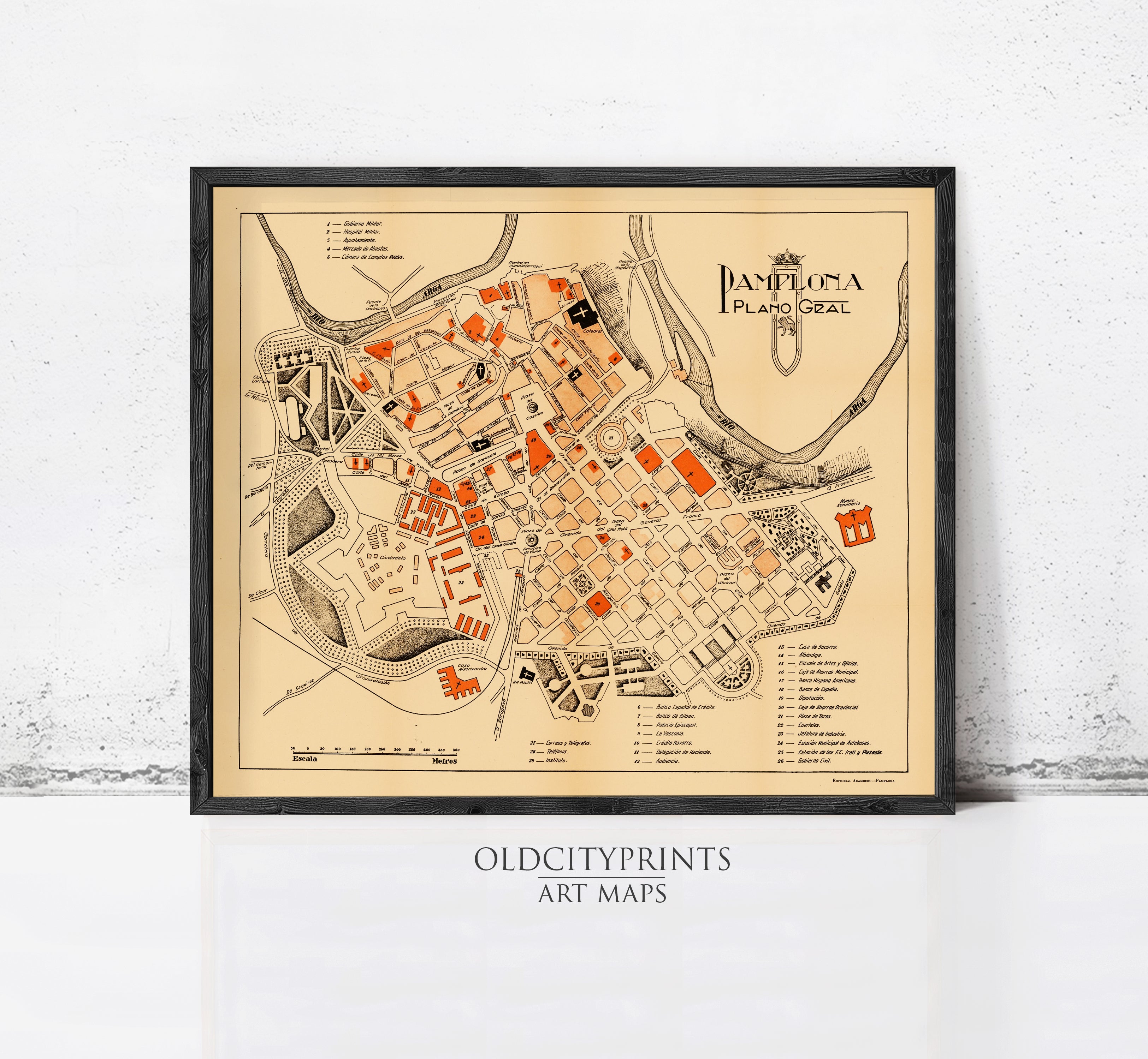 The image is a framed vintage map of the city of Pamplona, Spain, depicting the layout and various landmarks within the city.