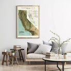 a framed vintage map of California, with a cozy living room setting in the background.