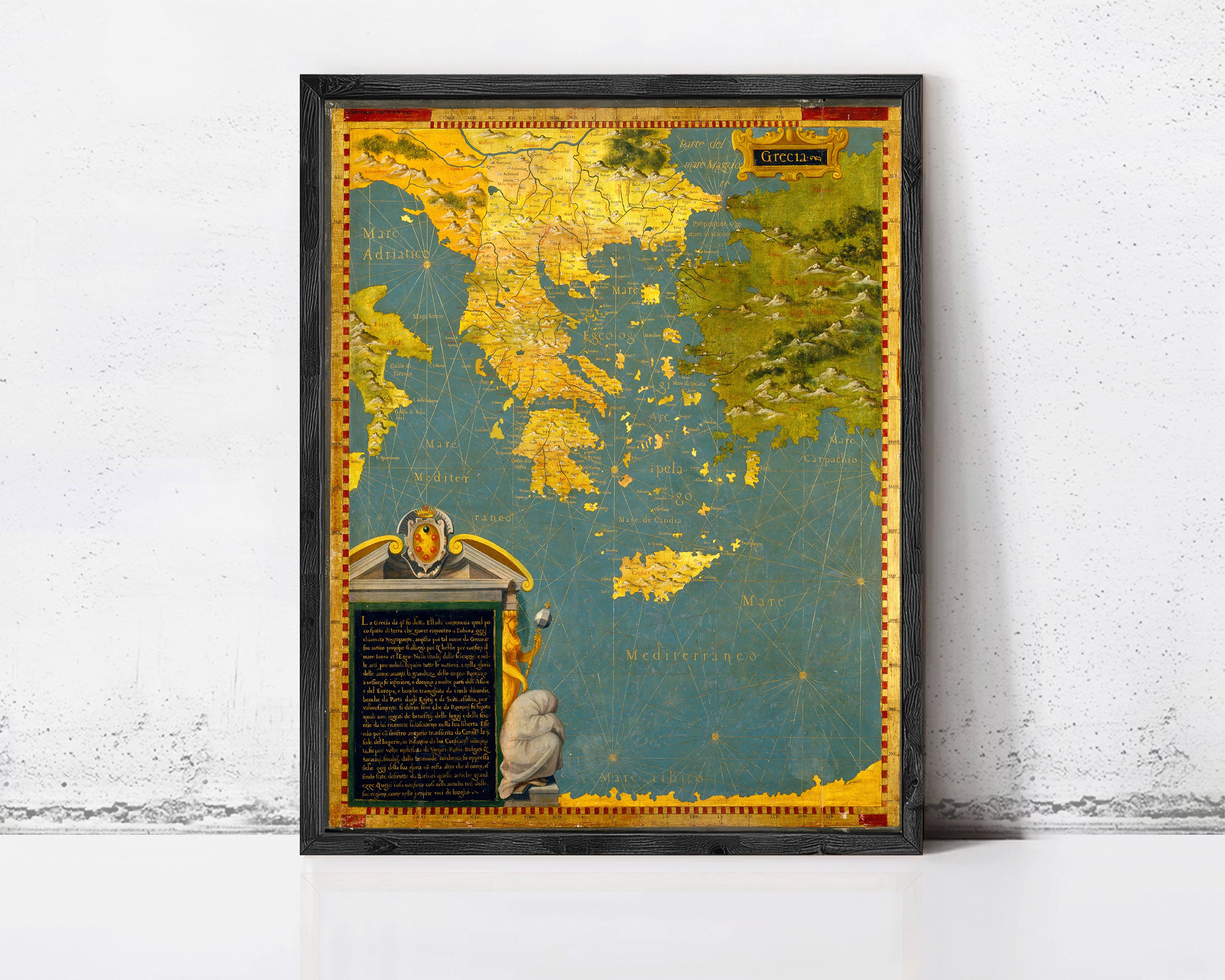 The image is a framed map of Greece, with a detailed and colorful depiction of the country's geography and surrounding areas.