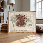 A framed map of Madrid, Spain, displayed on a wooden surface.