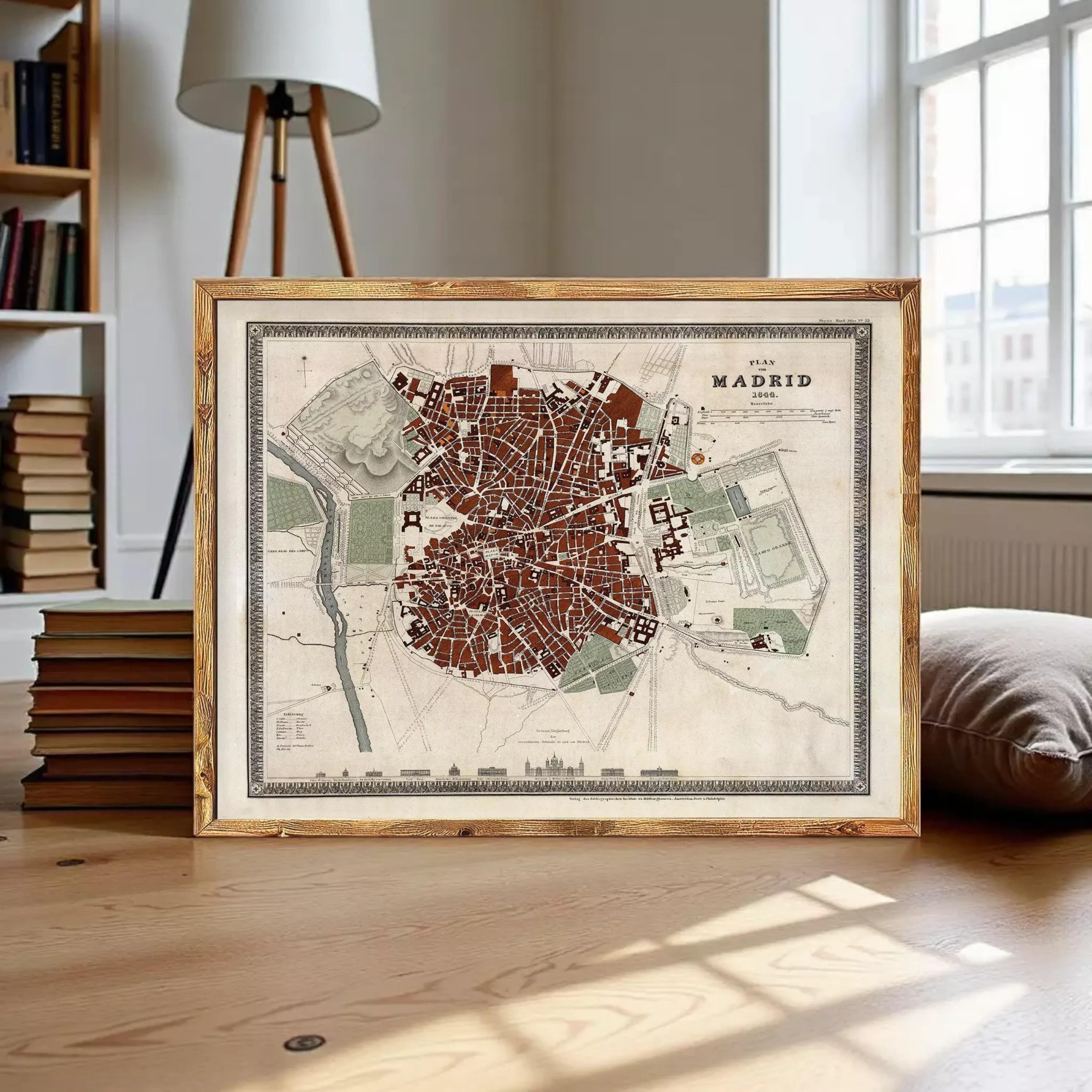 A framed map of Madrid, Spain, displayed on a wooden surface.