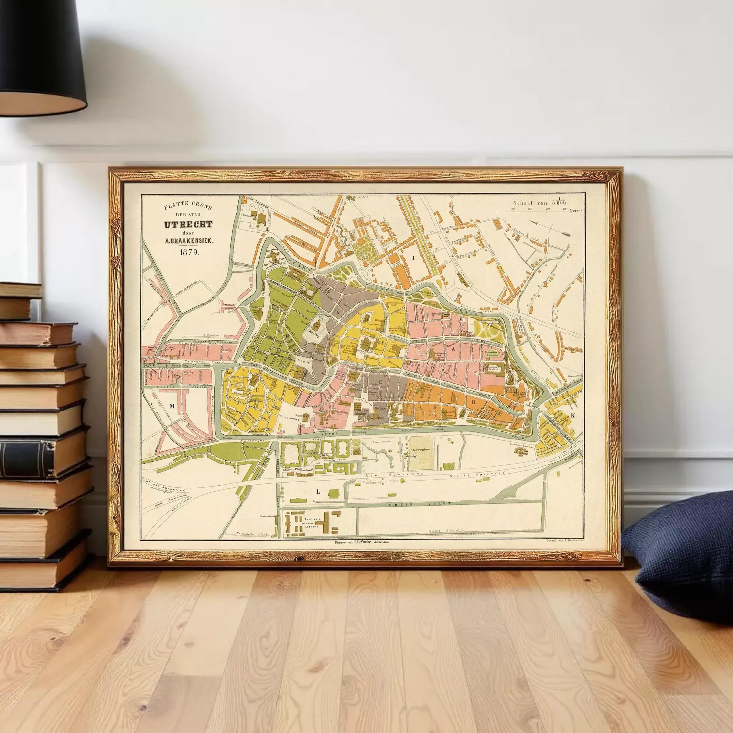 The image is a framed map of a city, likely from the 19th century, with various colored areas representing different neighborhoods or districts.