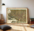 The image is a framed vintage map of a city, depicting a densely populated urban area with numerous buildings and streets.