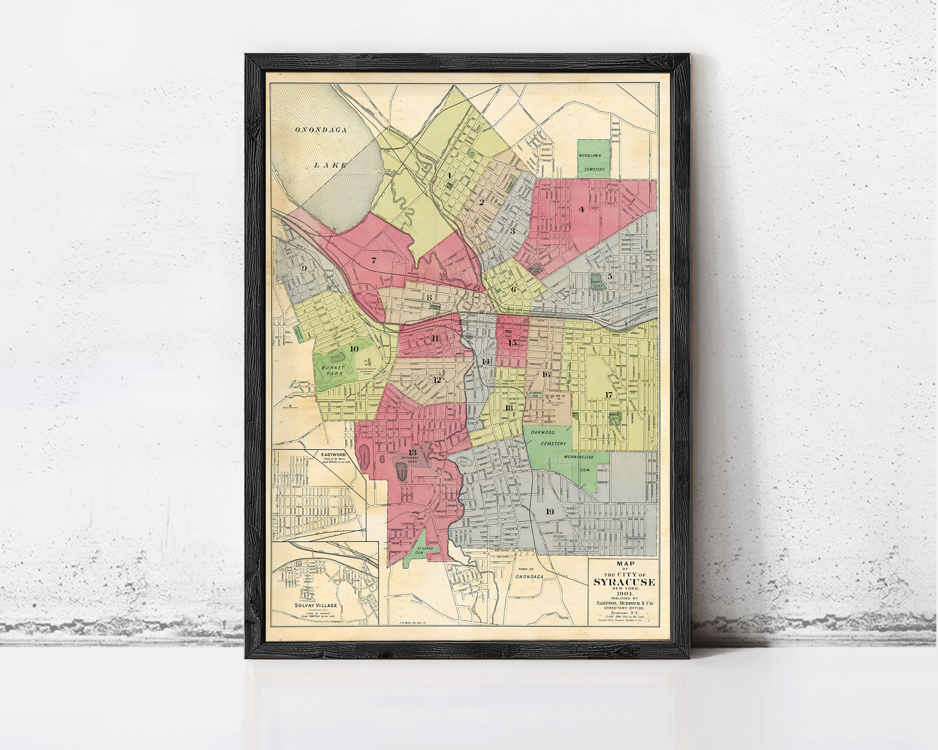 The image is a framed map of a city, showing various neighborhoods and streets.