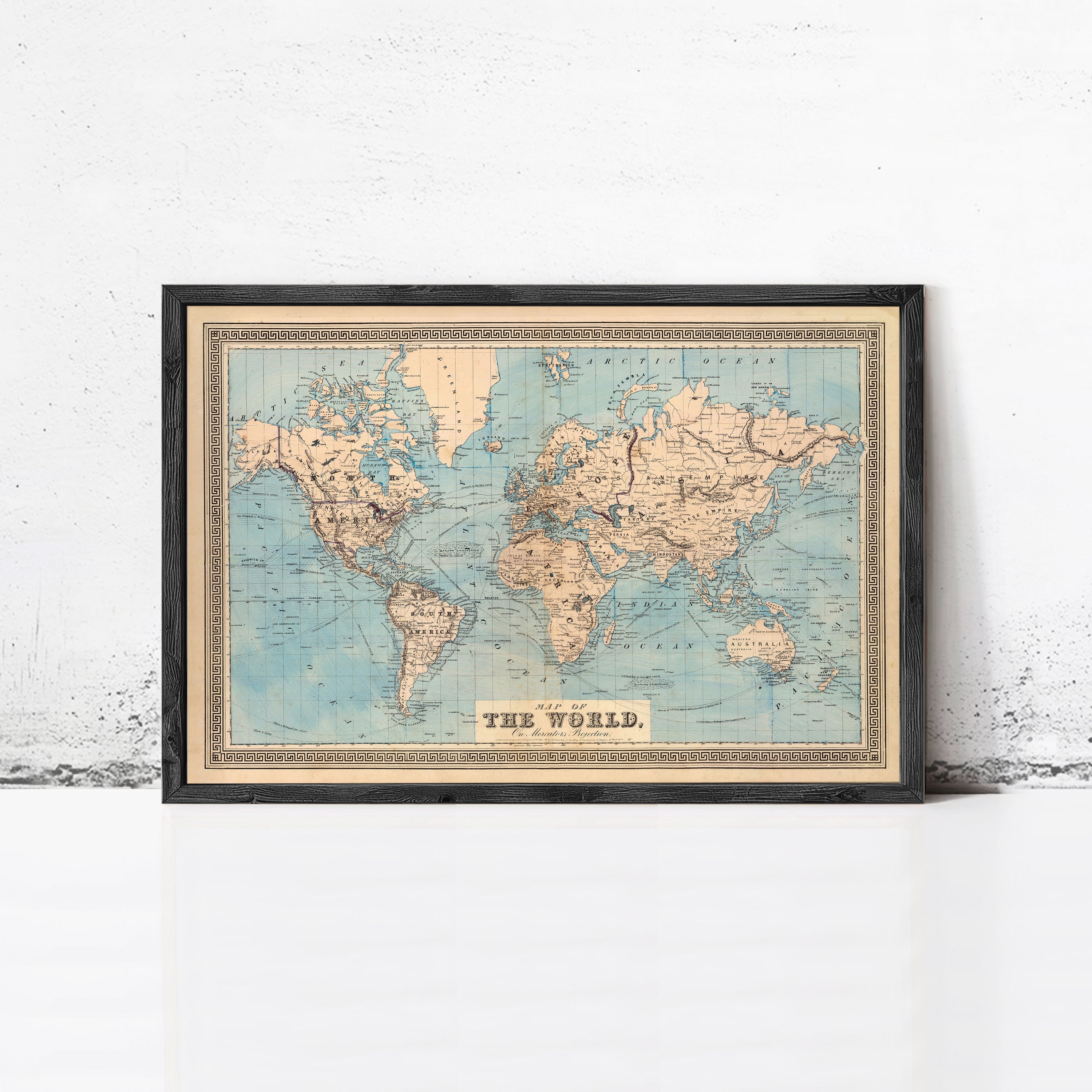 The image is a framed vintage world map with the title "The World" at the bottom.
