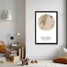 a cozy living room with a framed map of Bombay, a city in India, hanging on the wall. The room has a wooden floor, a chair, a lamp, and some books and toys scattered around.
