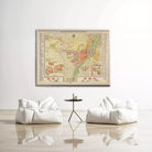 a large framed map hanging on a white wall, with two white bean bag chairs positioned in front of it.