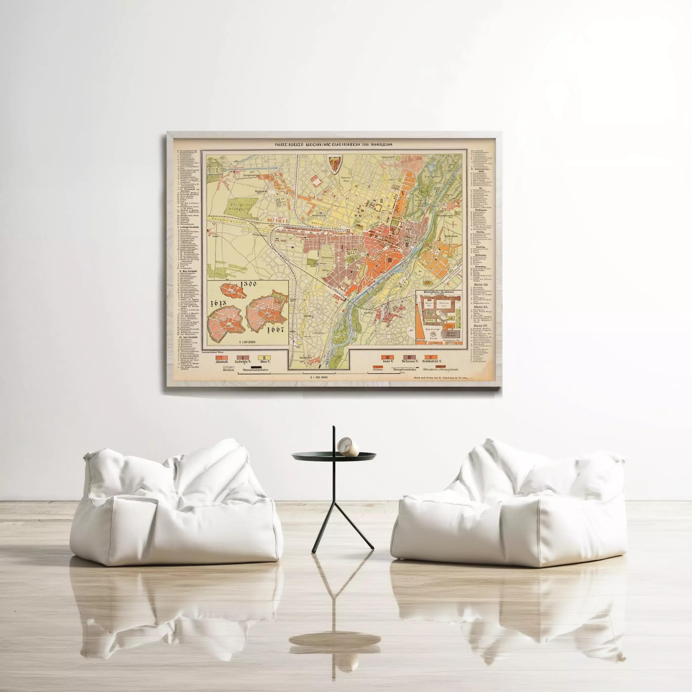 a large framed map hanging on a white wall, with two white bean bag chairs positioned in front of it.