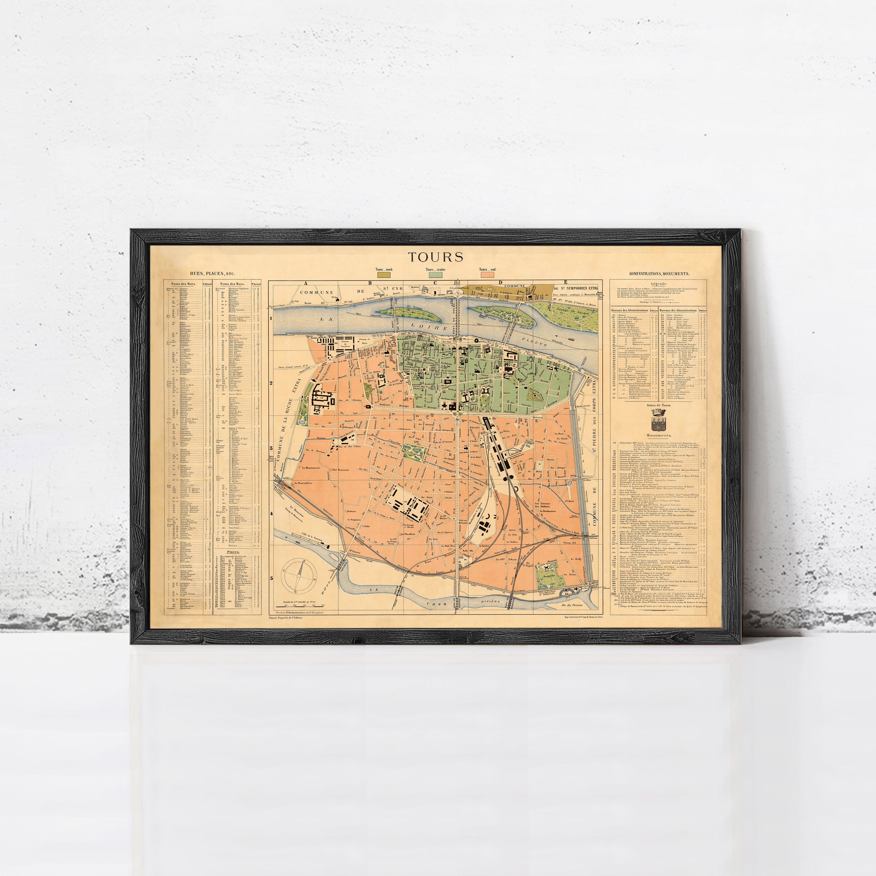 The image is a framed vintage map of a city, likely Paris, with various streets, landmarks, and a legend.