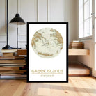 A framed map of the Greek islands is displayed in a room with a lamp, books, and a window.