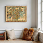 a framed map of China hanging on a wall, with a cozy corner with pillows and a stuffed animal nearby.