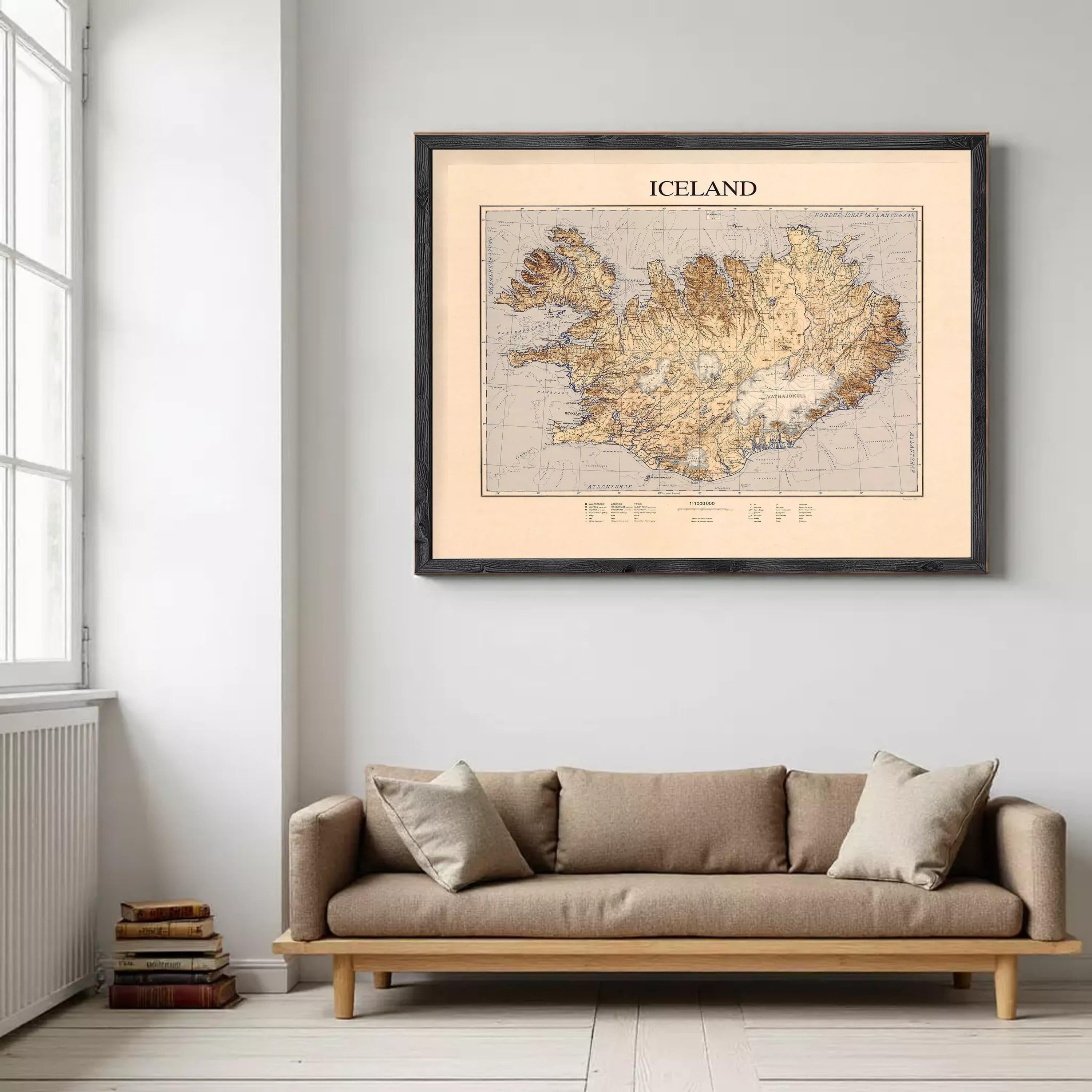 a cozy living room with a large framed map of Iceland hanging on the wall above a beige sofa.