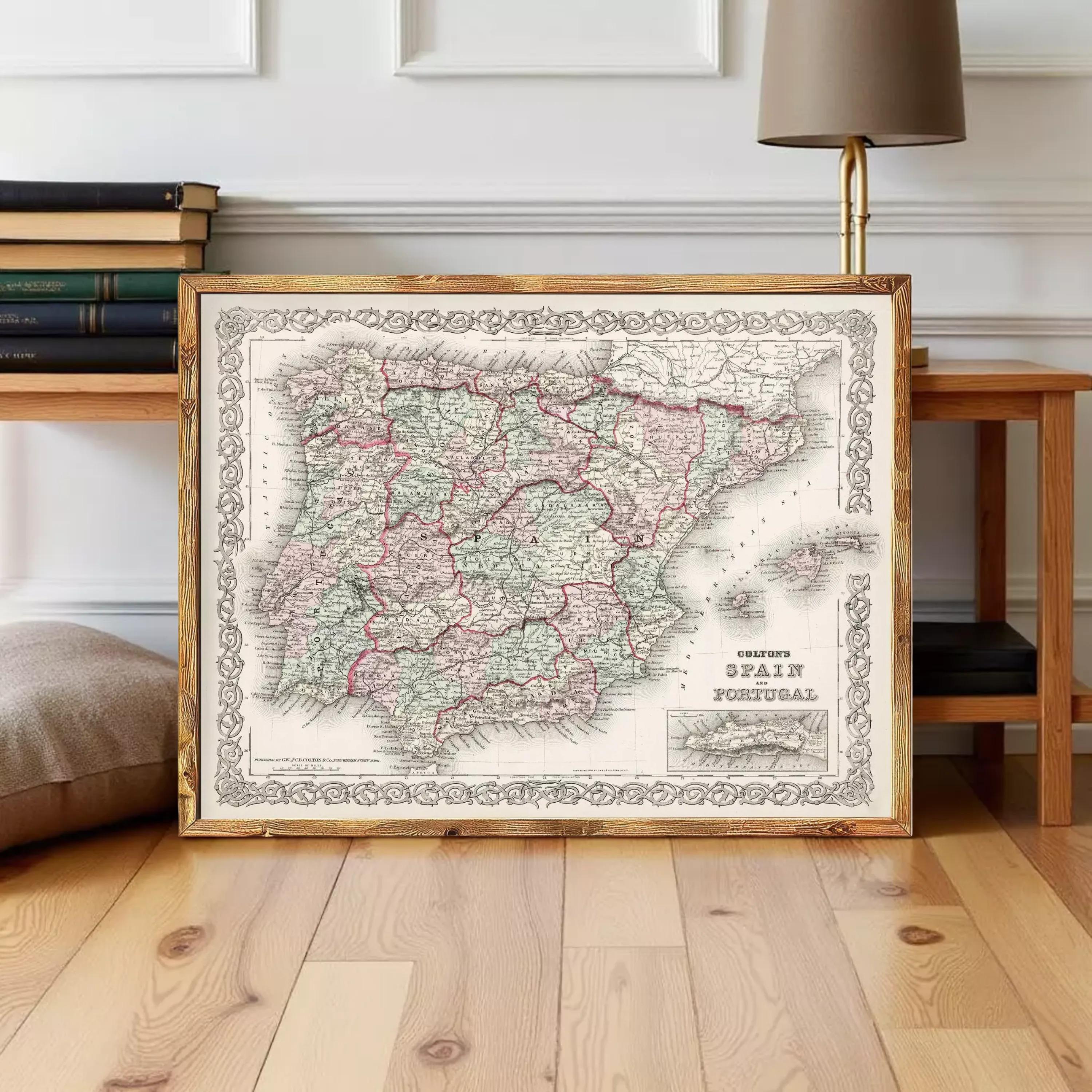 a framed map of Spain and Portugal, with a wooden floor and a lamp in the background.