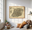 The image is a framed antique map of a city, likely from the 16th century, depicting a detailed layout of the city's streets and surrounding areas.