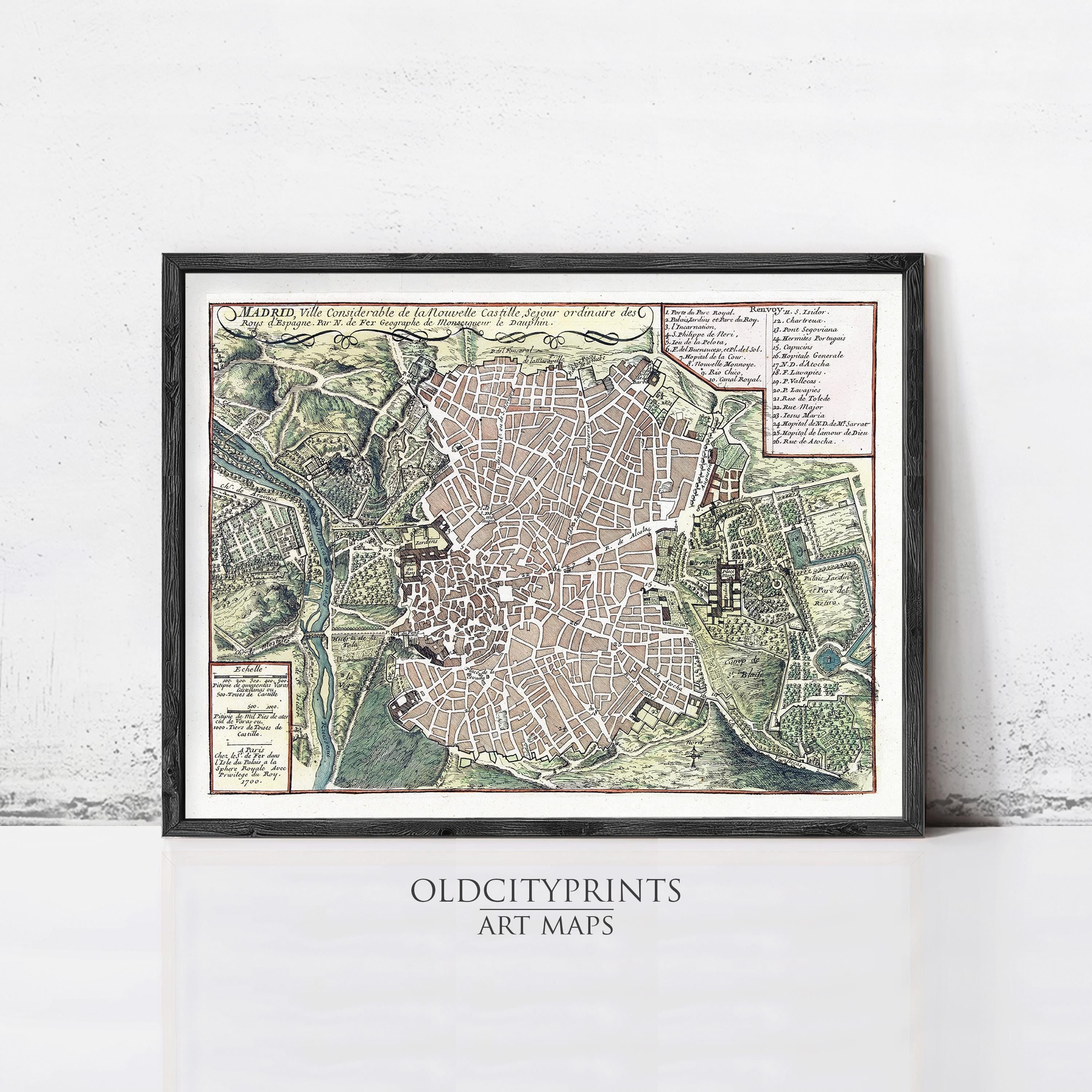 The image is a framed vintage map of a city, likely from the 16th century, with detailed cartography and a focus on the urban layout.