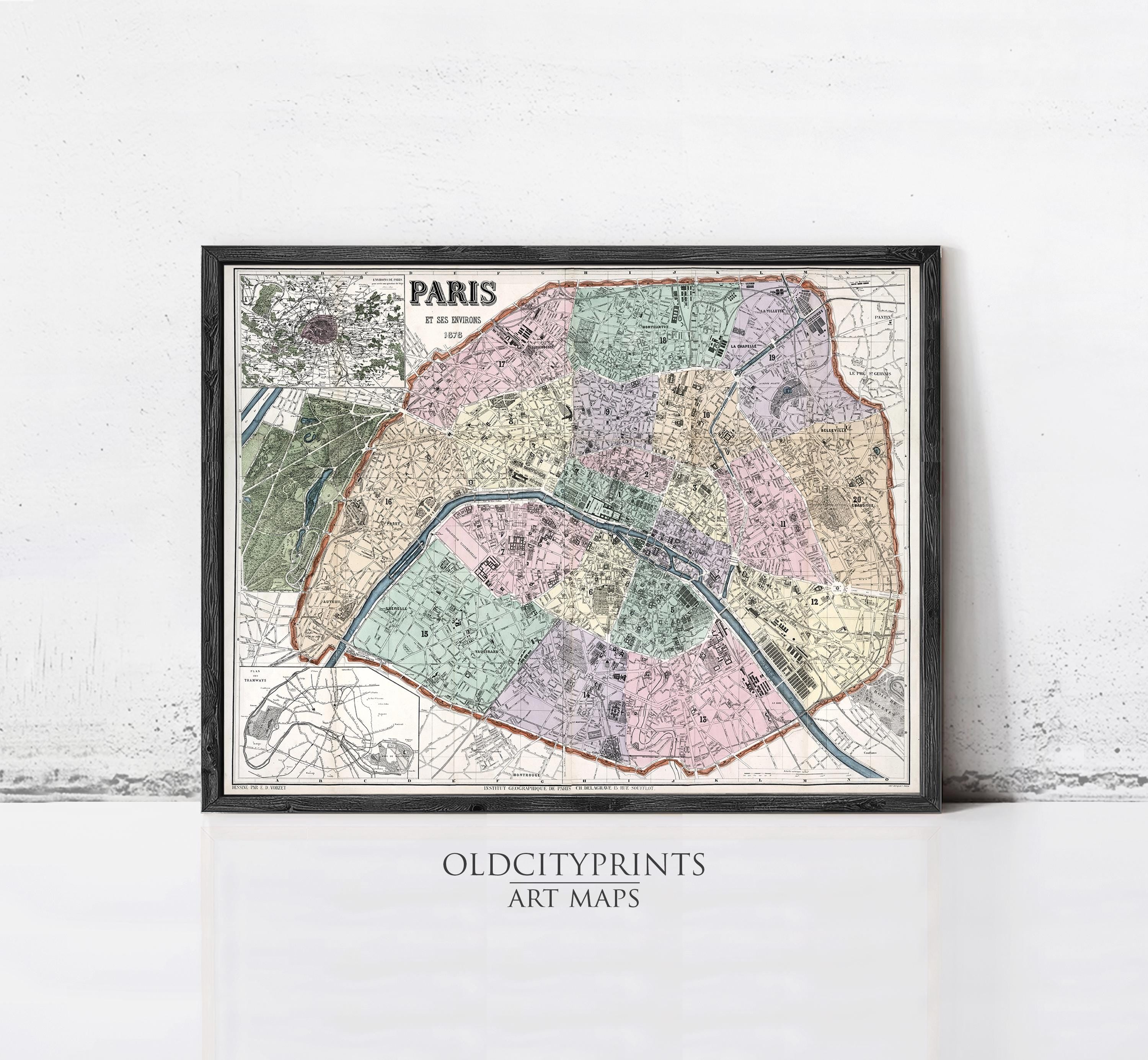 The image is a framed vintage map of Paris, France, depicting the city's streets and neighborhoods in a detailed and colorful manner.